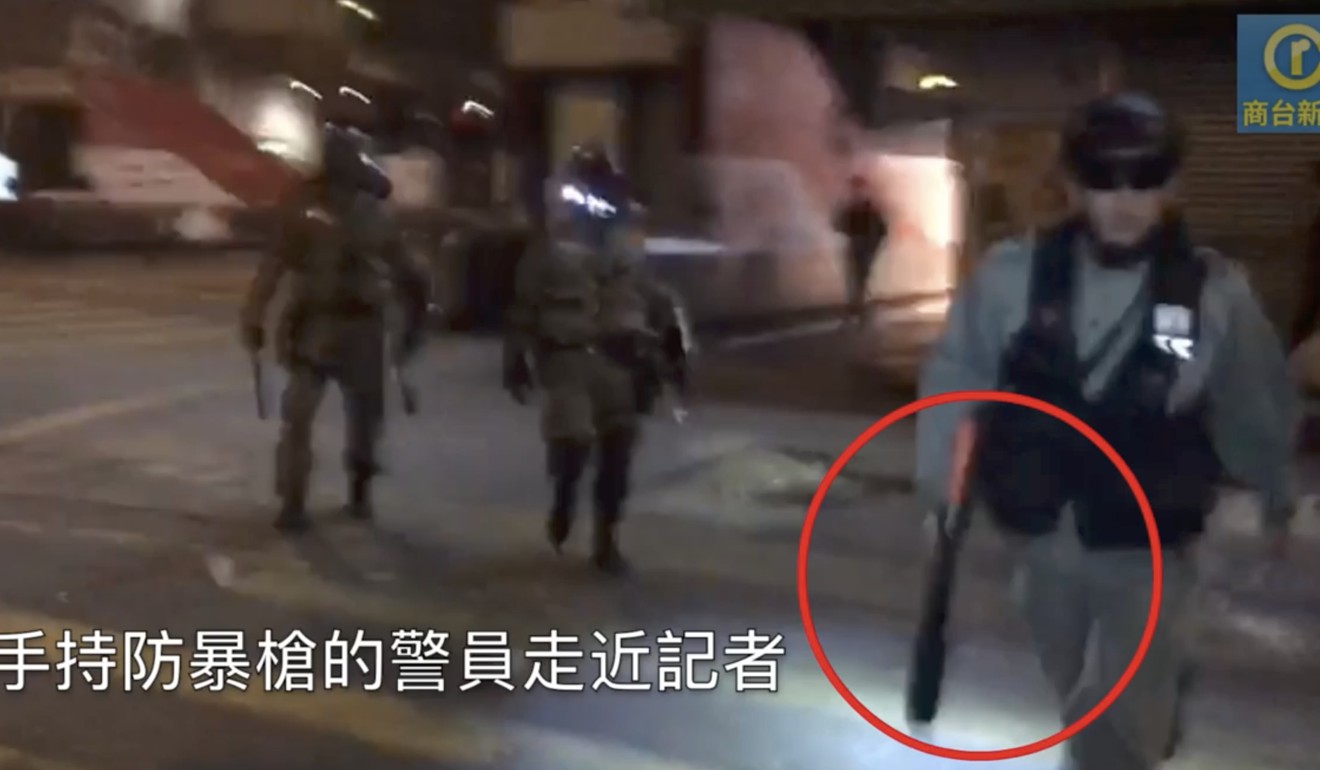 Another screen grab from the video depicting the incident, showing an officer holding what appears to be a gun for crowd control. Photo: Commercial Radio