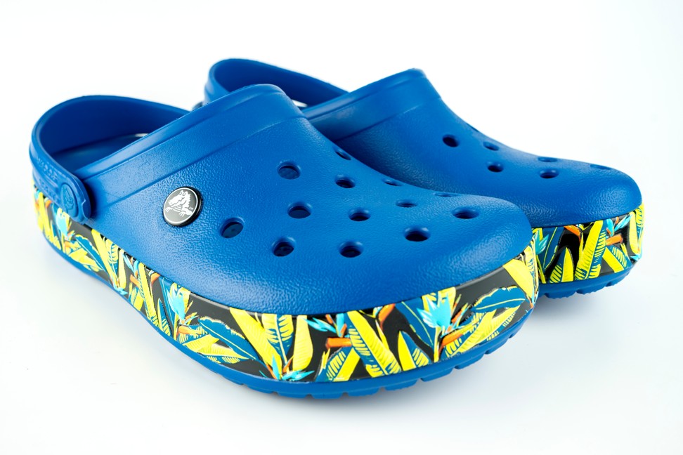 A pair of blue Crocs with a printed sole. Photo: Shutterstock