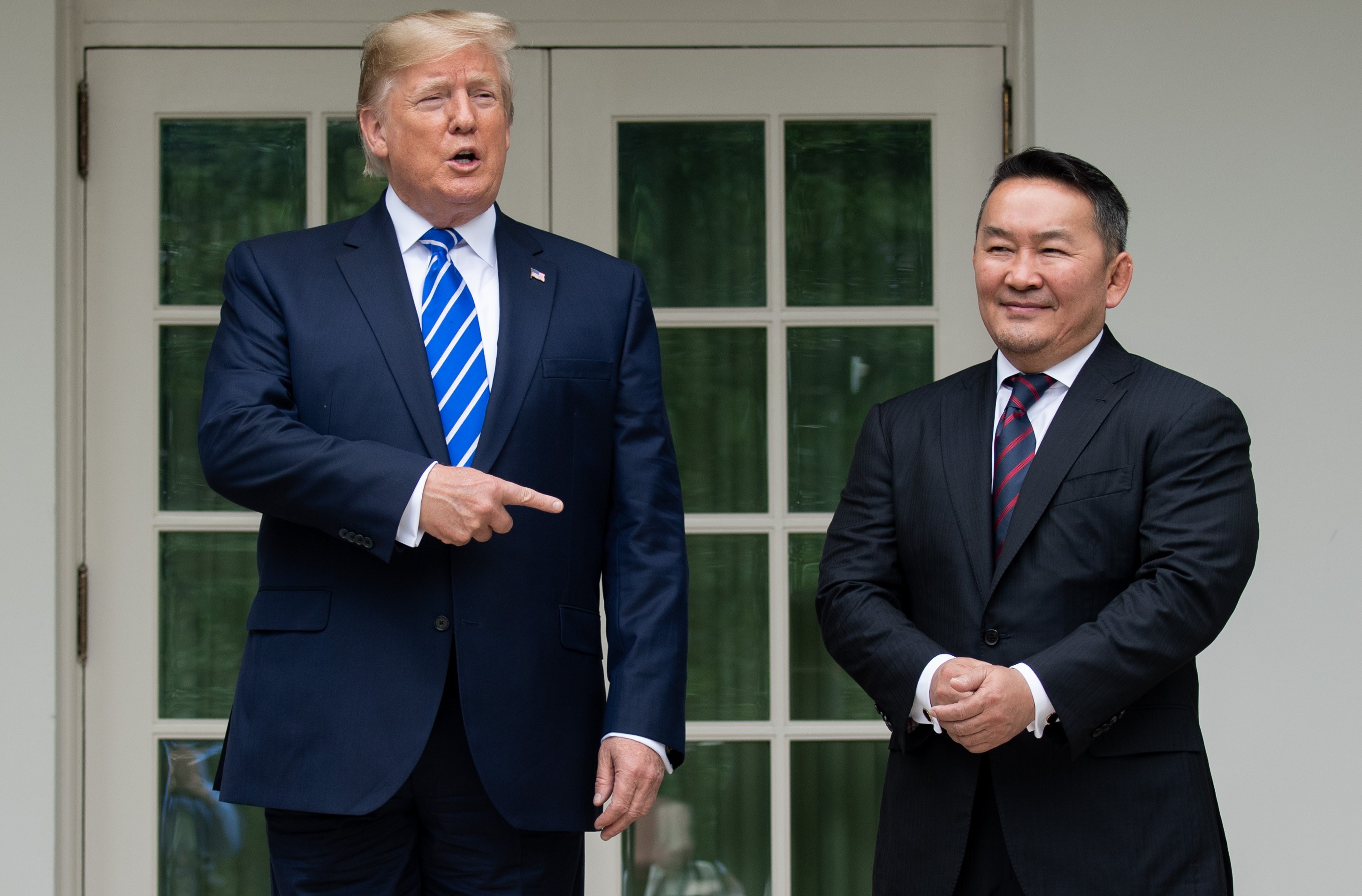 US President Donald Trump speaks with reporters as he welcomes Mongolian President Khaltmaagiin Battulga in the Rose Garden of the White House in Washington on July 31. Photo: AFP