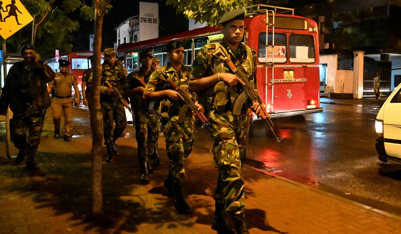 Sri Lankan Special Task Force (STF) personnel stand guard as election officials carry ballot boxes. Photo: AFP