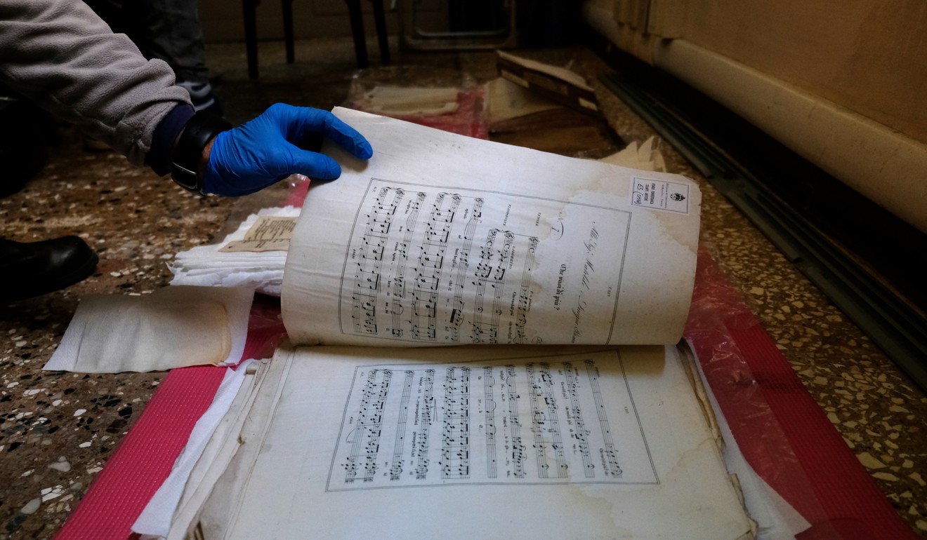 Volunteers save music sheets from the Venice floods. Photo: Reuters