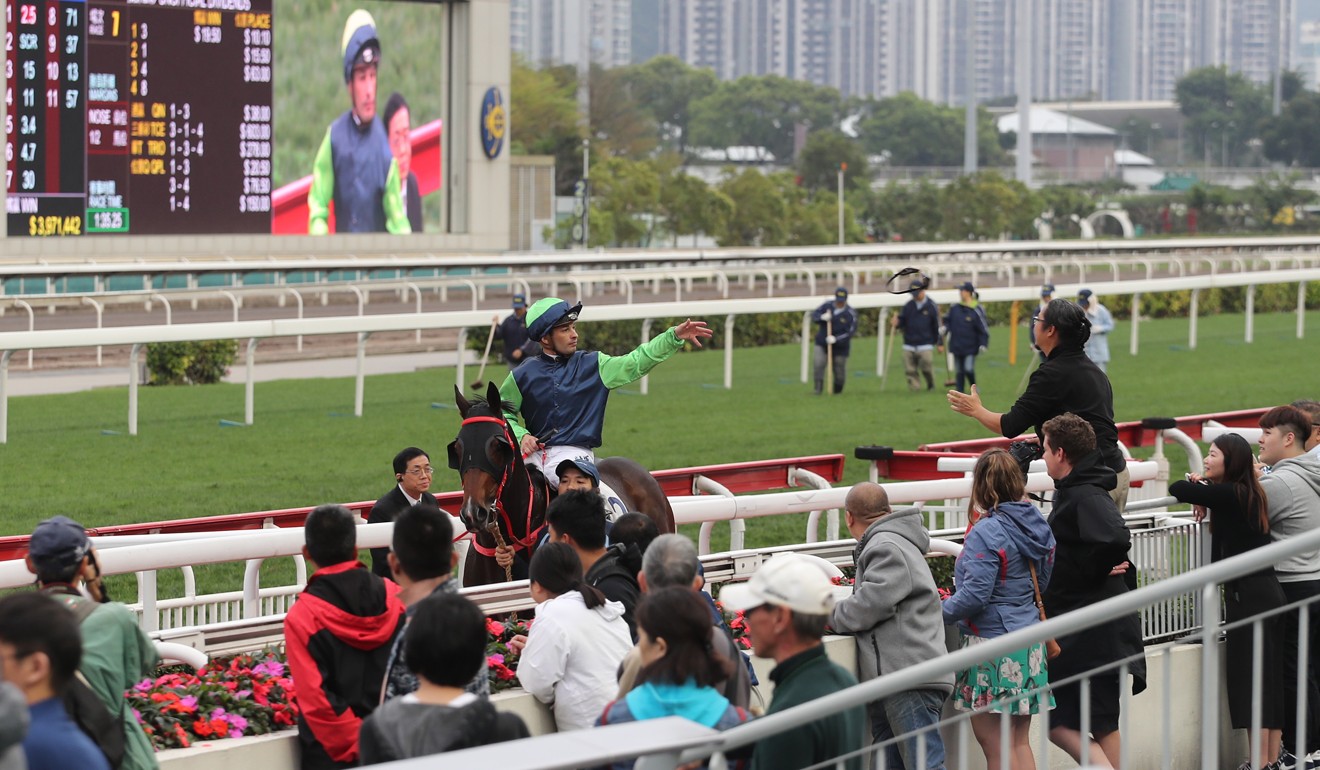 Silvestre de Sousa throws his goggles into the crowd after winning.