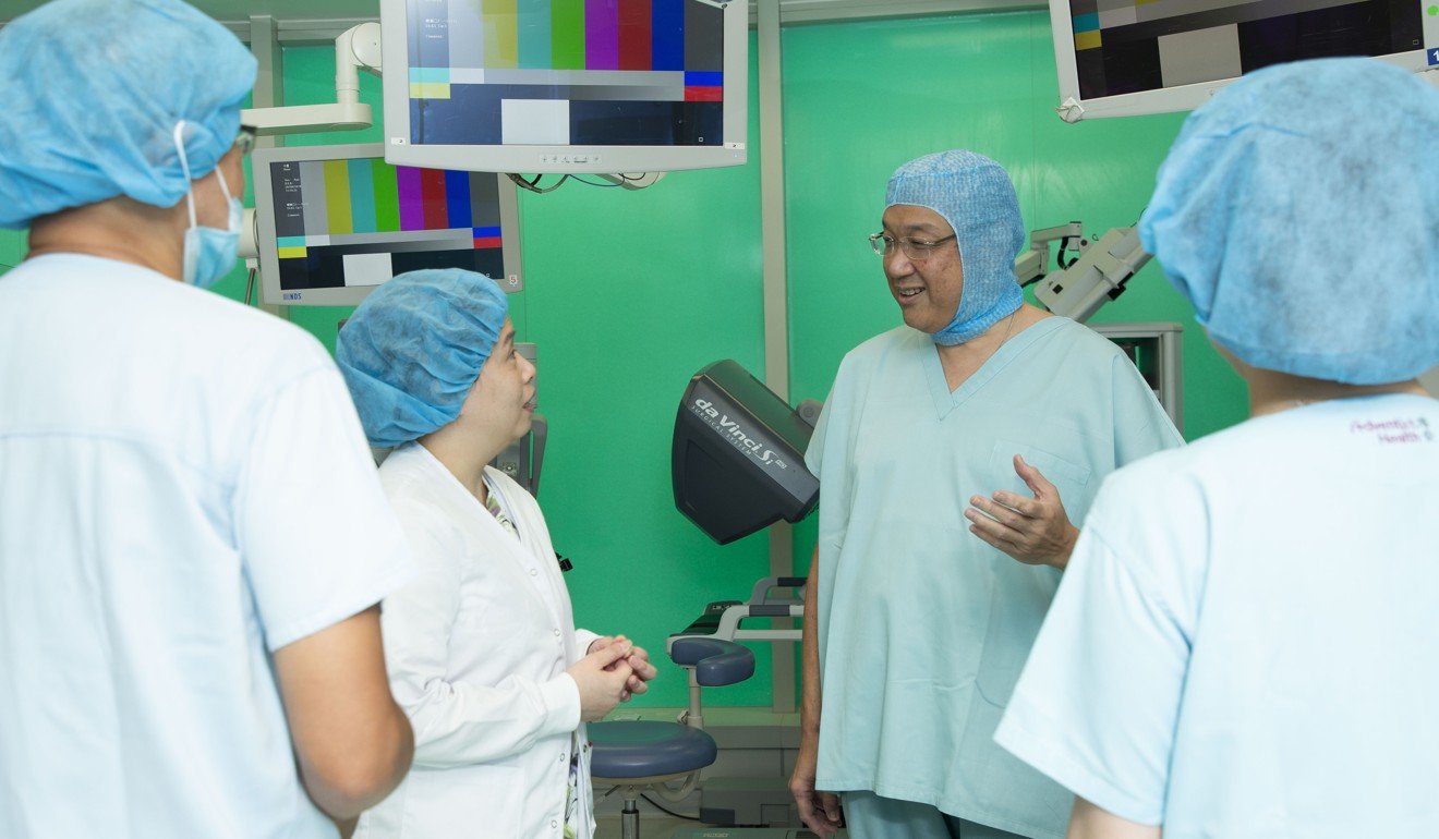 Dr Daniel Mok (centre) chats to medical staff in the operating theatre at Hong Kong Adventist Hospital– Stubbs Road. Photo: Frank Freeman