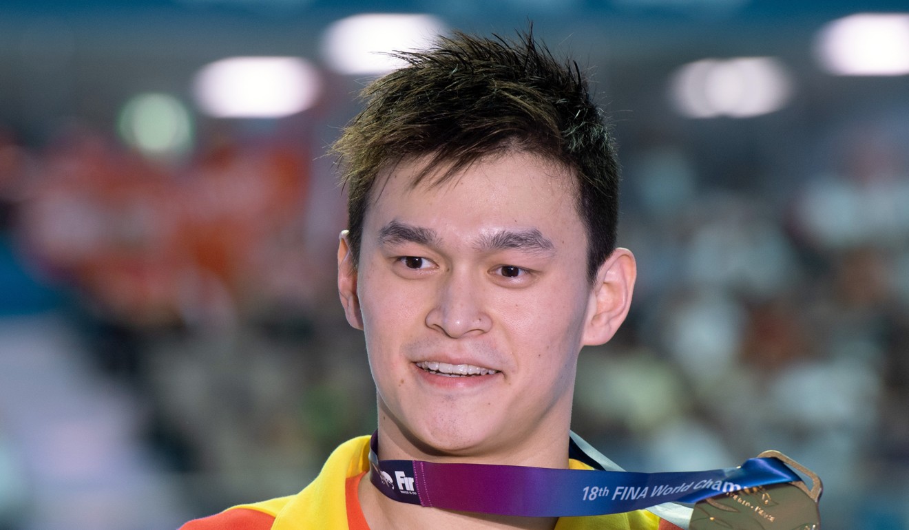Sun Yang holds his gold medal after wining the 200m freestyle at the 2019 world championships in South Korea. Photo: DPA