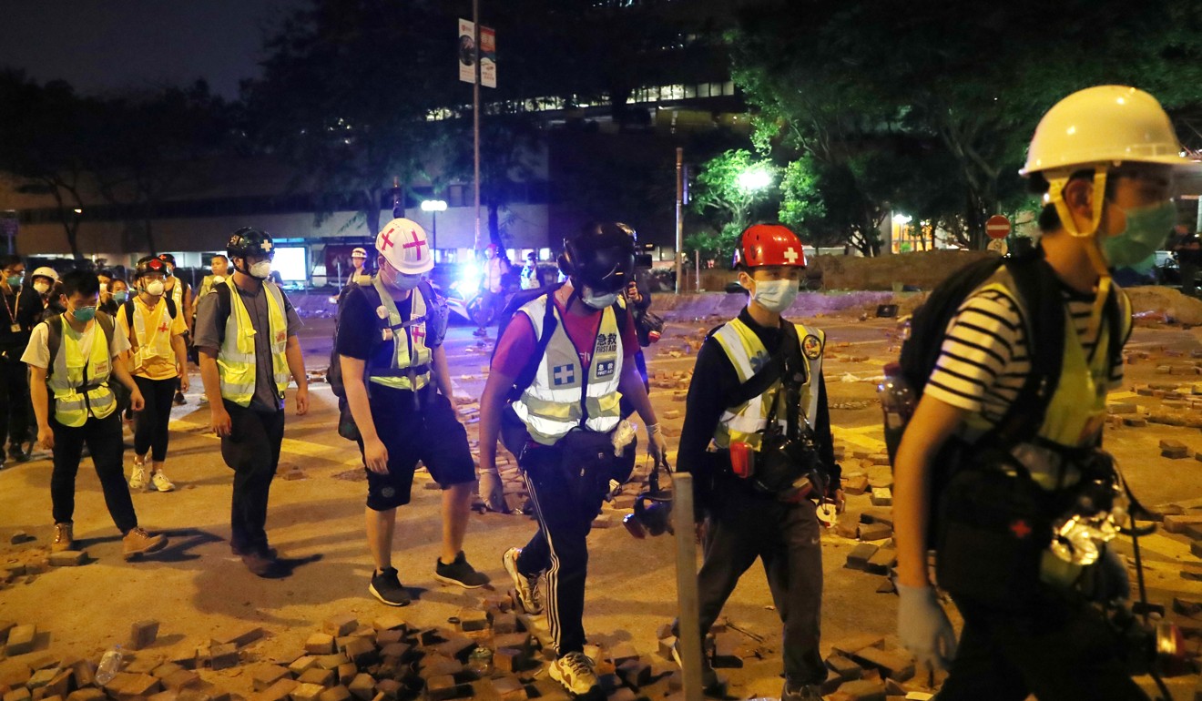 First aid volunteers are allowed to leave the PolyU campus after identity recorded. Photo: Sam Tsang
