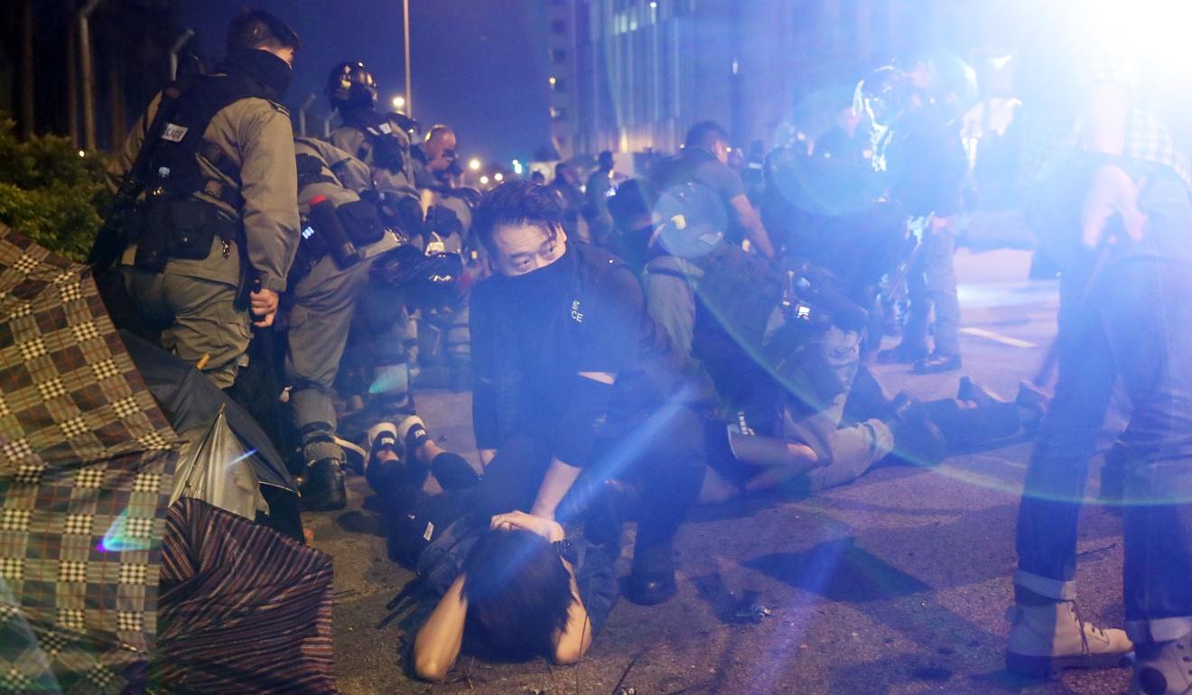 A group of protesters who tried to flee are arrested by police officers outside the PolyU campus. Photo: Sam Tsang