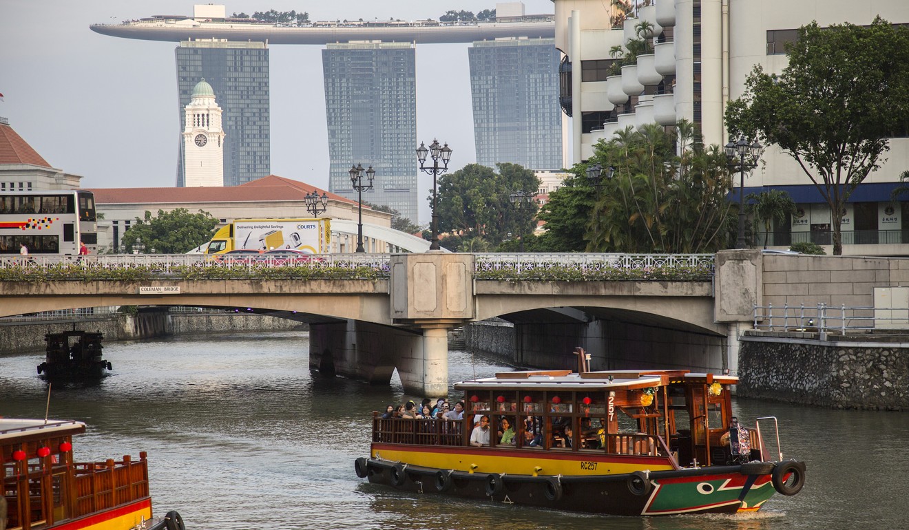 Passengers travel by boat along the Singapore River at Boat Quay. Photo: Bloomberg