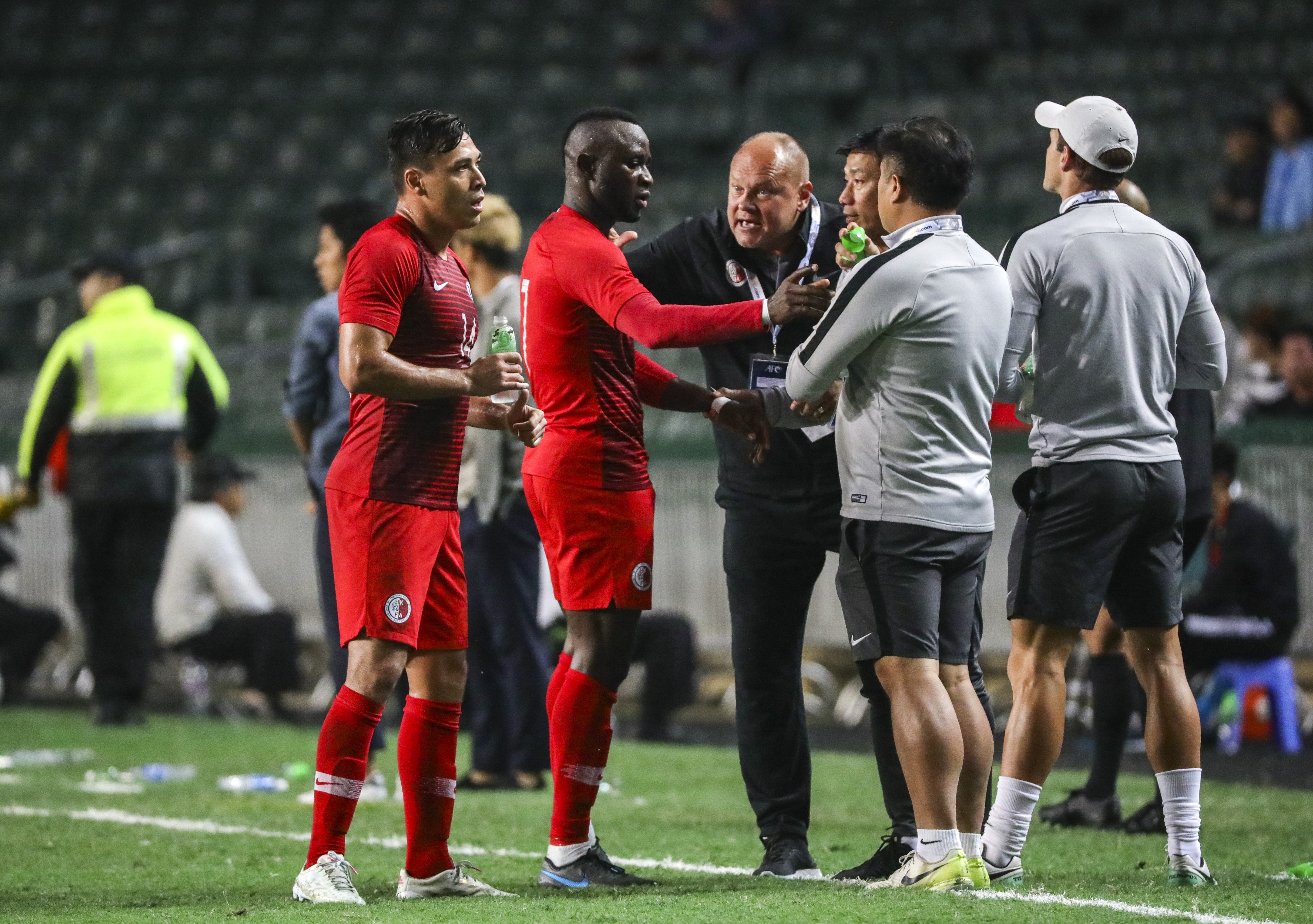 Hong Kong coach Mixu Paatelainen (centre) gives instructions to Alex Akande (second from left) and James Ha (left) in their World Cup qualifier against Cambodia. Photos: May Tse