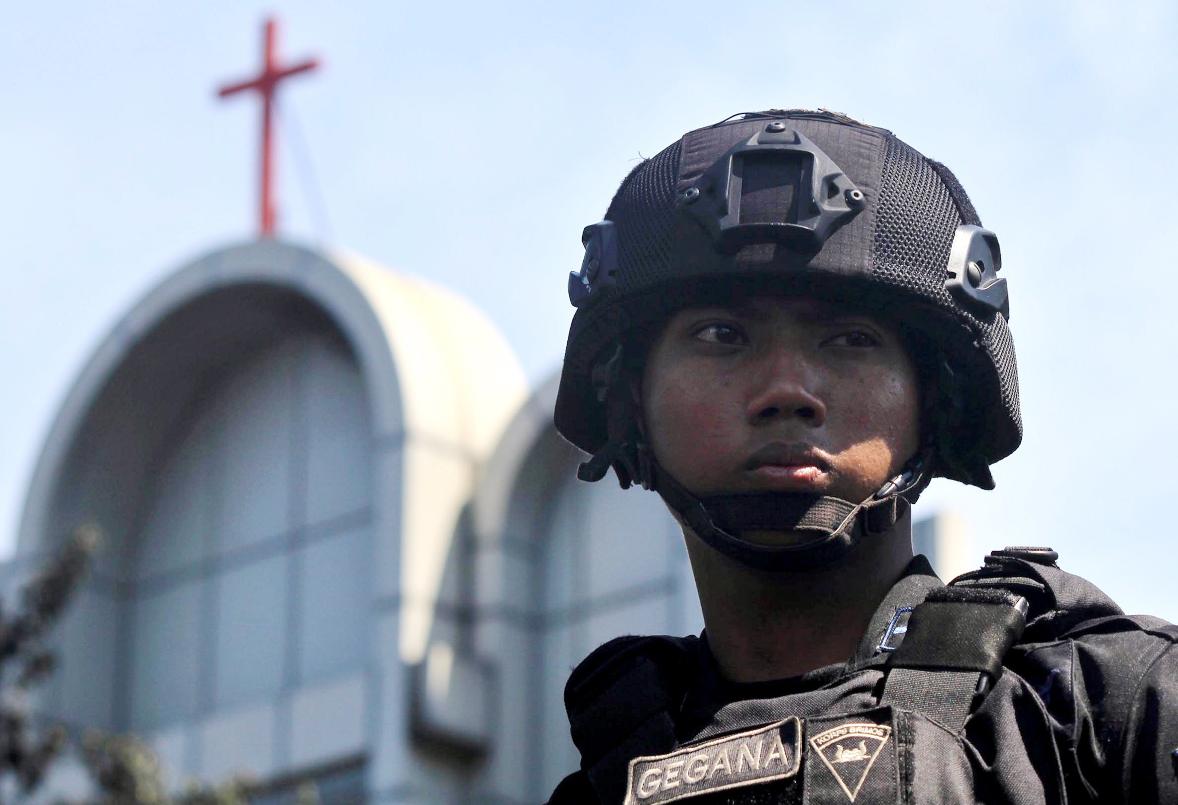 An Indonesian police officer stands guard in May last year near the scene of a bomb blast by a church in Surabaya, East Java, Indonesia. Photo: EPA