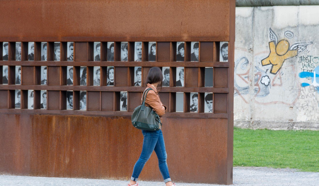 The Berlin Wall Memorial, with images of people killed, on Bernauerstrasse. Photo: Alamy