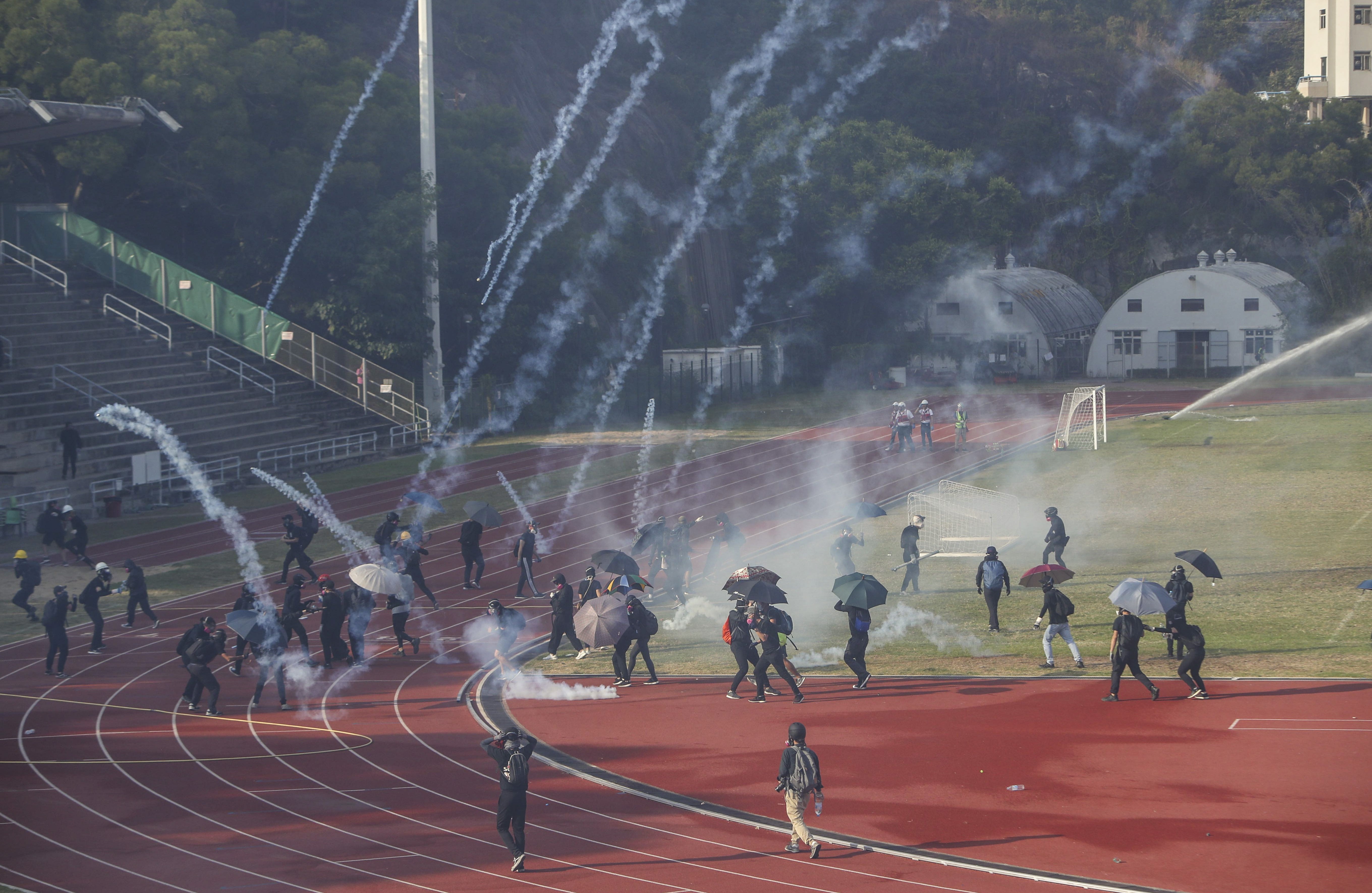 Protesters at Chinese University in Sha Tin face tear gas fired by the police on November 12. Photo: Winson Wong