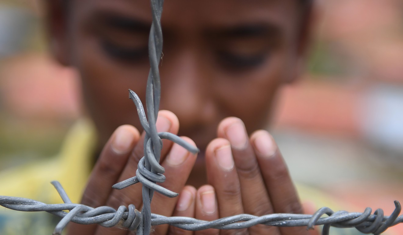 A Rohingya refugee performs prayers as he attends a ceremony to commemorate the military crackdown that prompted a massive exodus of people from Myanmar to Bangladesh. Photo: AFP