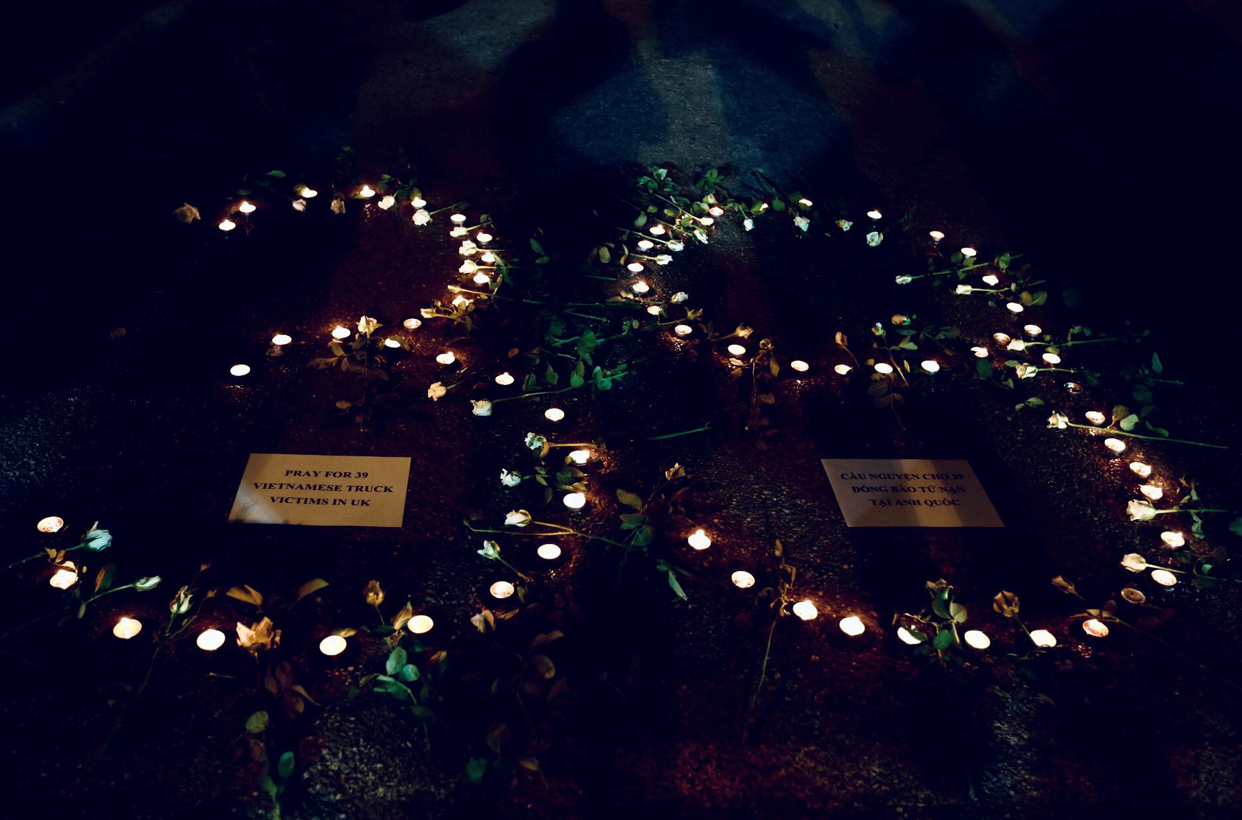 Candles are lit during a prayer for 39 people found dead in the back of a truck near London, in Hanoi. Photo: Reuters