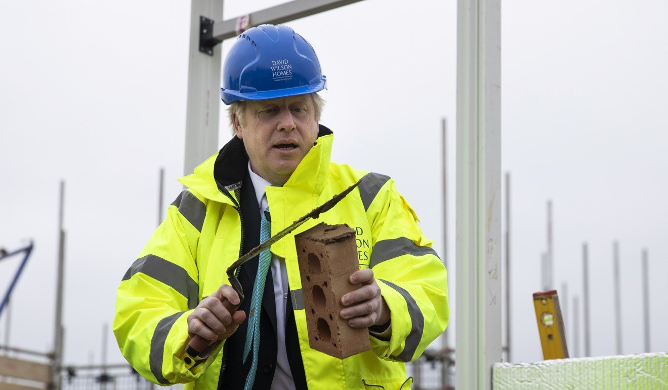 Britian's Prime Minister Boris Johnson prepares to lay a brick while on the hustings. Photo: Reuters