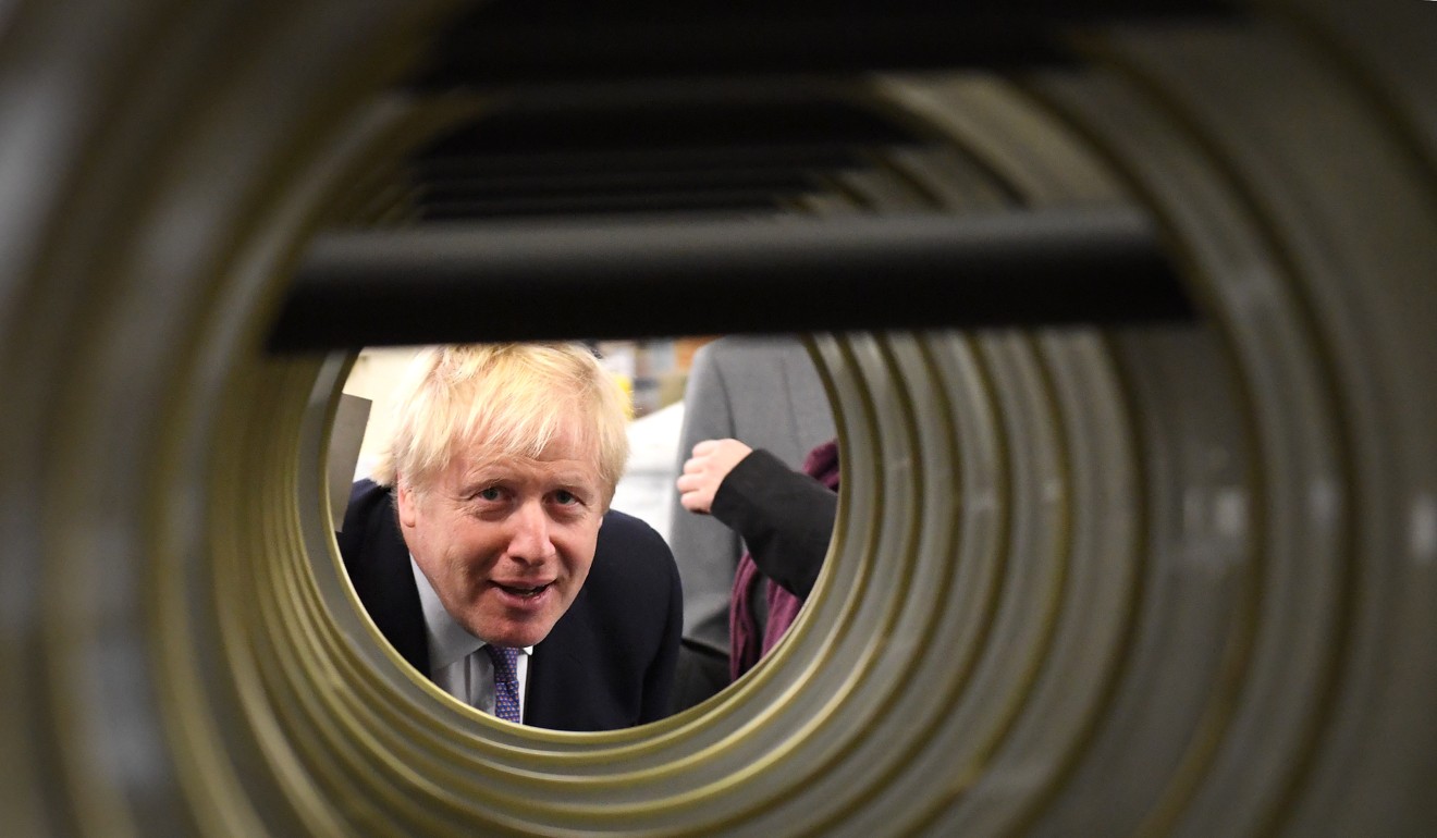 Britain’s Prime Minister Boris Johnson visits a the washing machine factory. Photo: DPA