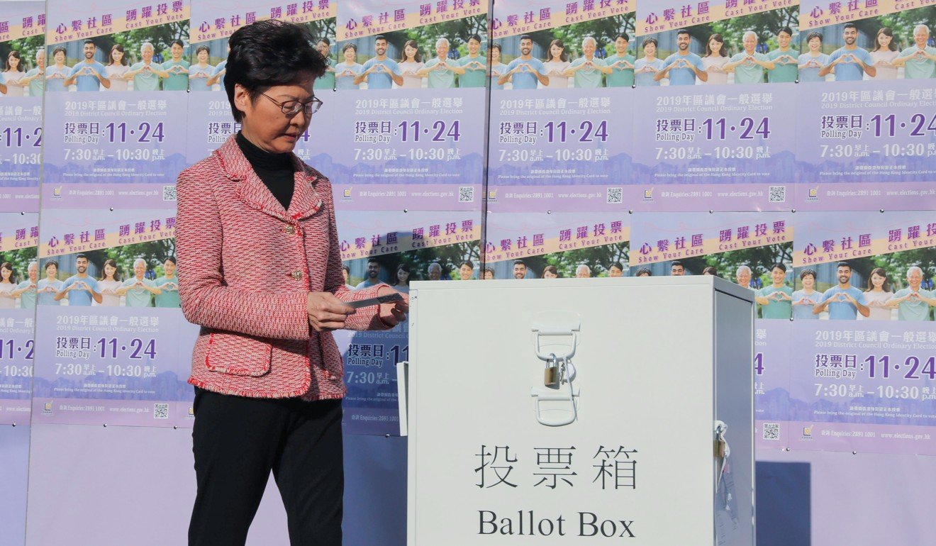 Carrie Lam casts her vote at Raimondi College before appealing for the relative calm in the city to continue after the elections. Photo: K. Y. Cheng
