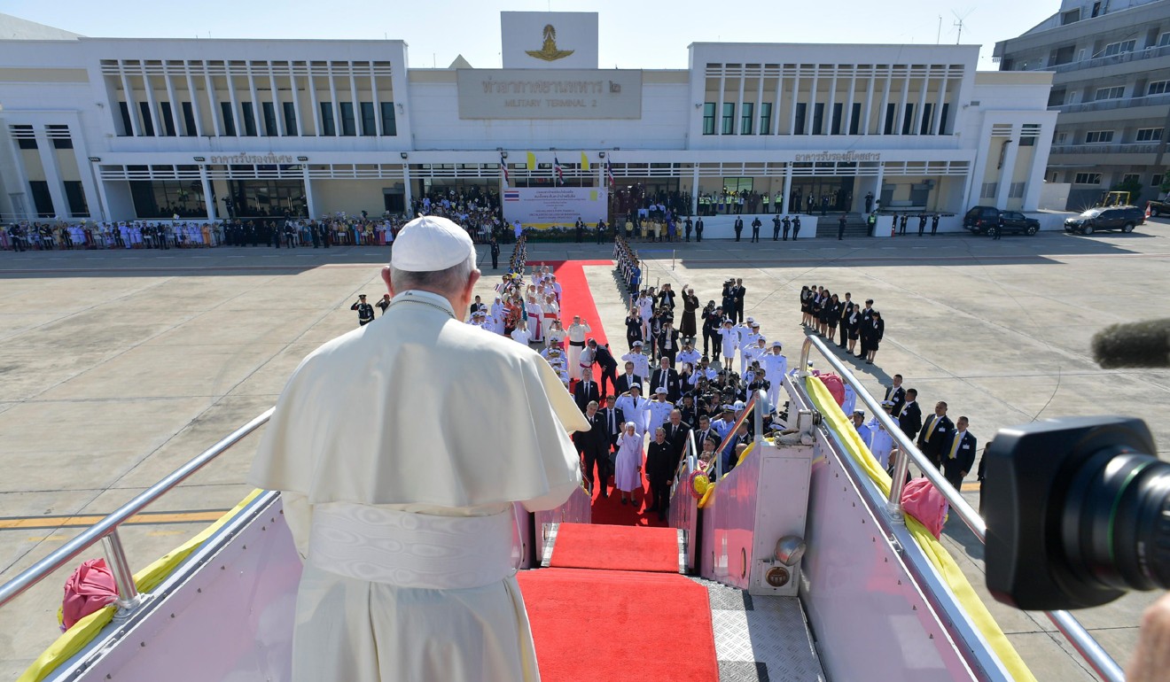 Pope Francis boarding his plane as he departs from Bangkok's military airport. Photo: Handout via AFP