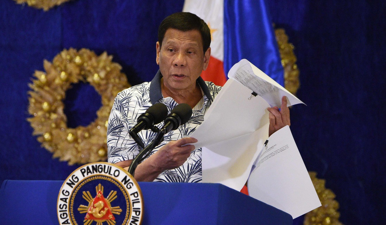 Philippine President Rodrigo Duterte shows documents during a press conference at Malacanang Palace in Manila. Photo: AFP