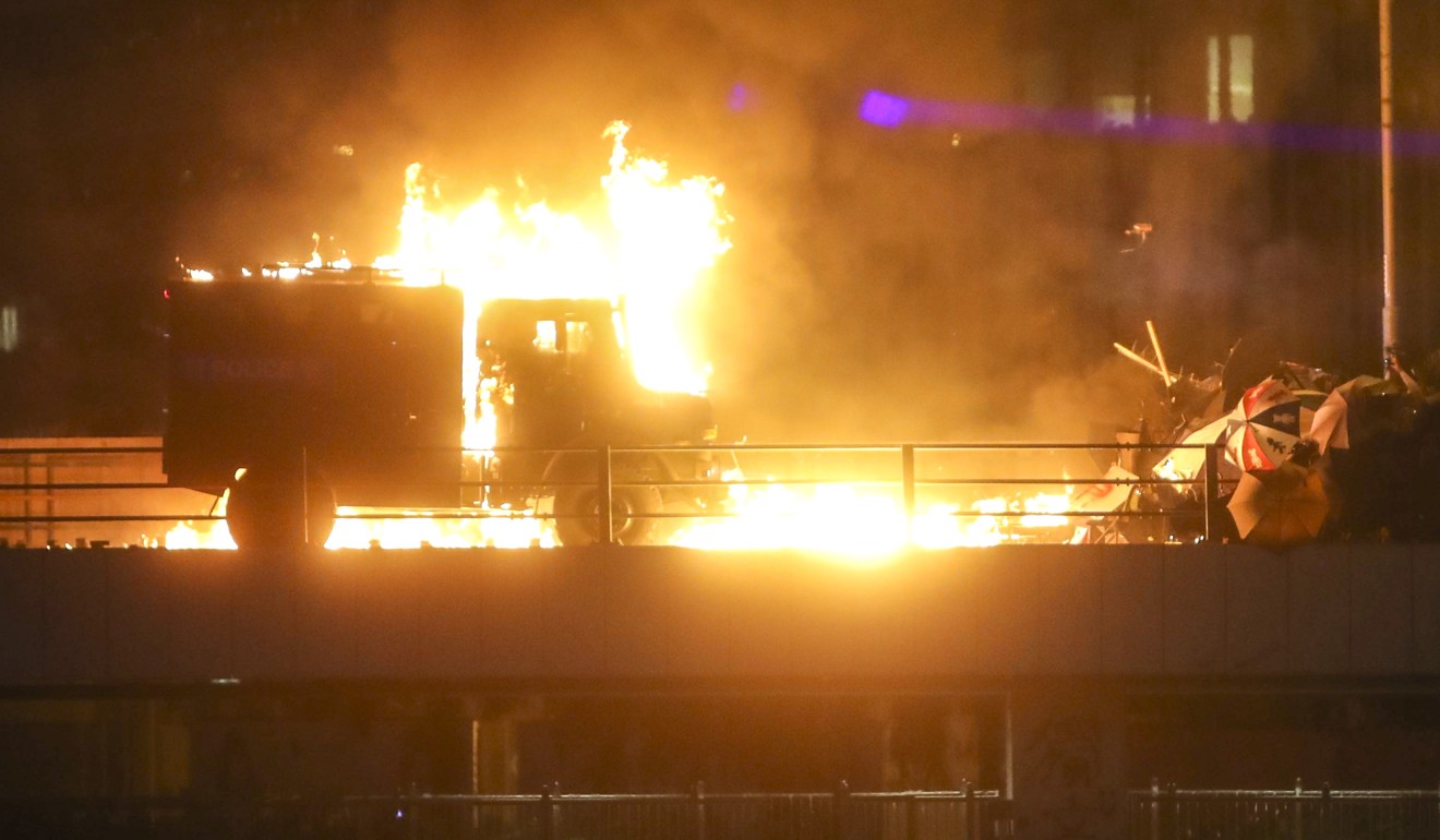 A police armoured vehicle set on fire during clashes between riot police and students near Hong Kong Polytechnic University. Photo: Winson Wong