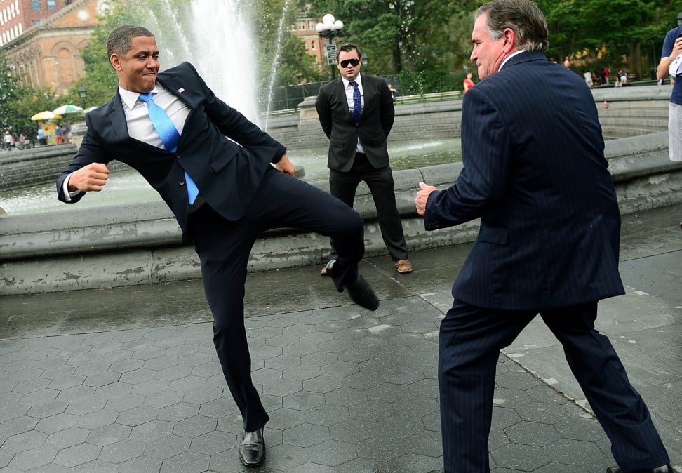 US Presidential candidate Mitt Romney impersonator Mike Cote ‘fights’ US President Barack Obama impersonator Reggie Brown, in Washington Square Park in New York in 2012. Photo: AFP