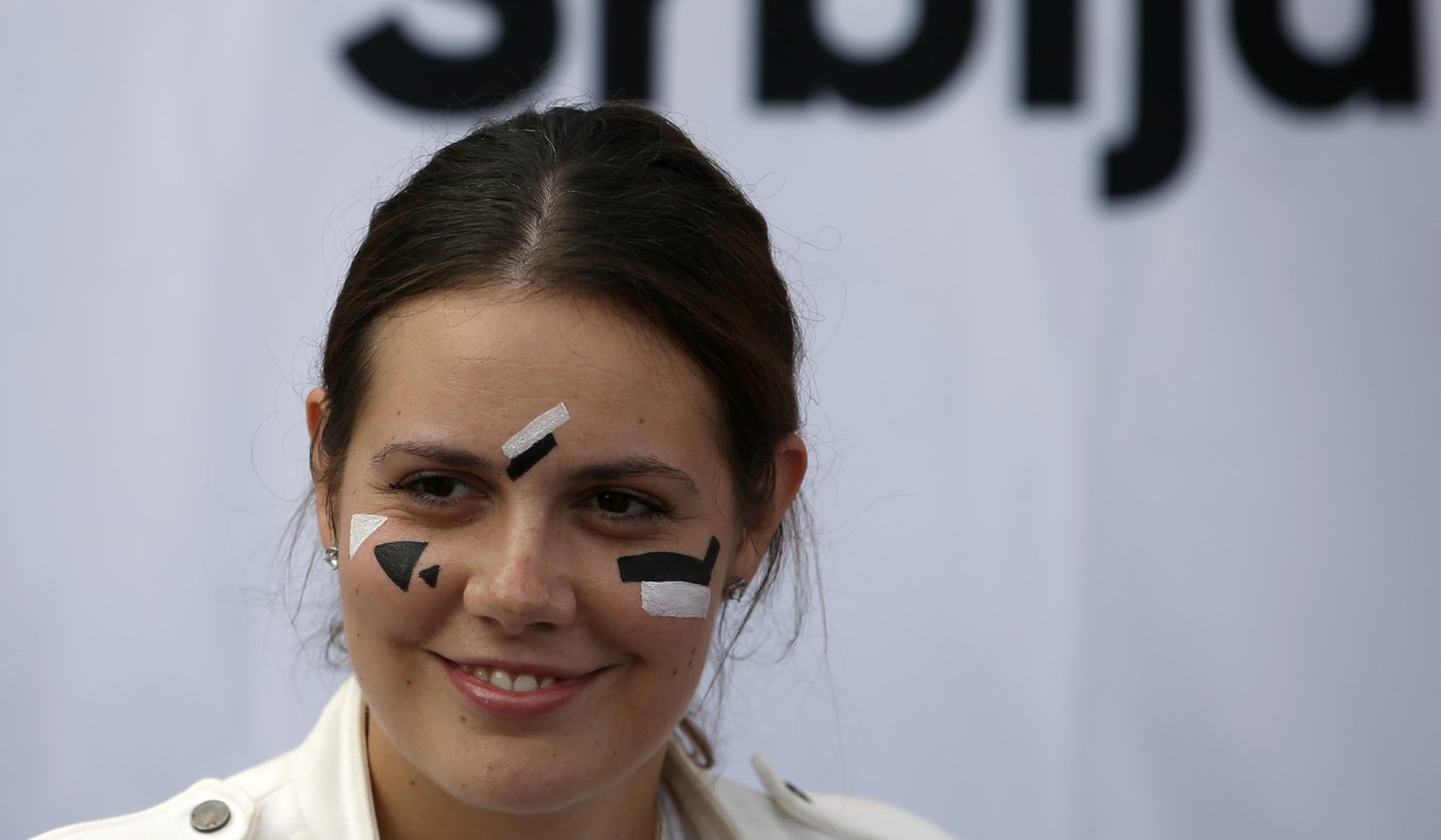 A young Serbian rights group activist has her face painted to confuse Huawei surveillance video cameras with face-recognition software installed in Belgrade. Photo: AP/Darko Vojinovic