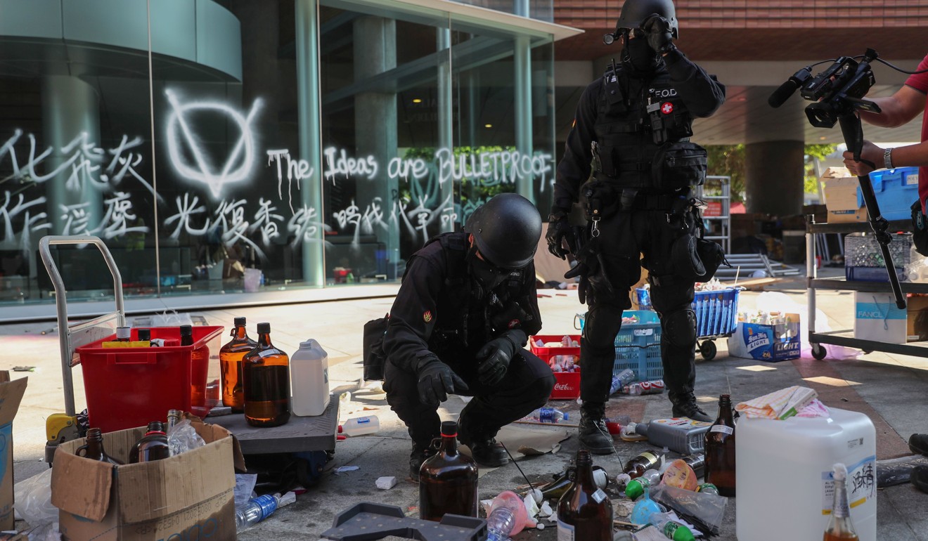 Bomb disposal officers investigate a suspect package after entering Polytechnic University on Thursday. Photo: Sam Tsang