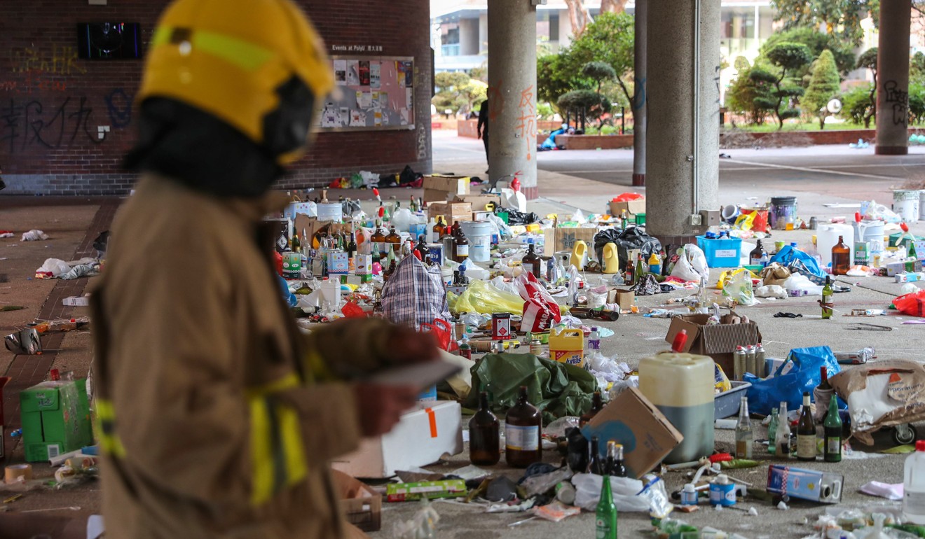 A firefighter begins to search for flammable items left behind by protesters inside Polytechnic University. Photo: Sam Tsang