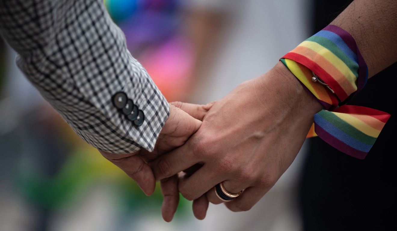 A same-sex couple hold hands during an event to raise awareness of gay rights in Hong Kong on May 25. Photo: AFP