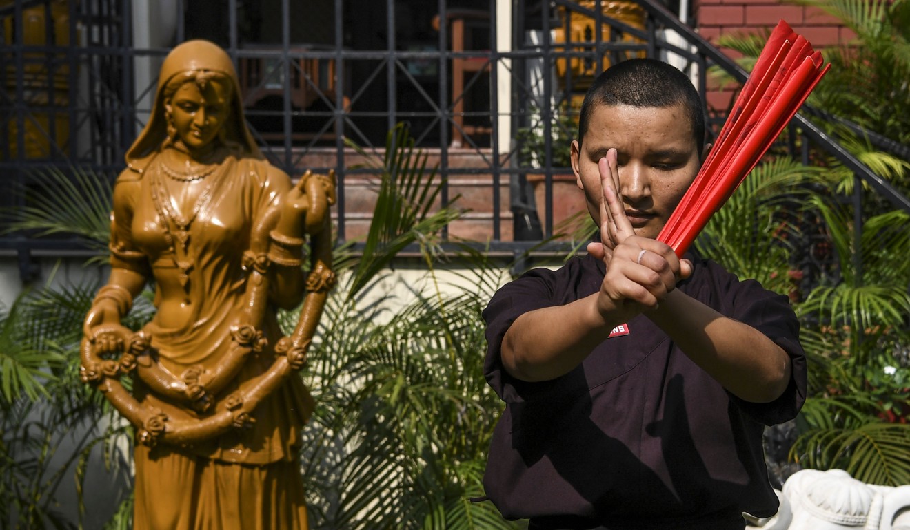 A member of the Kung Fu Nuns group demonstrates her skills in New Delhi. Photo: AFP