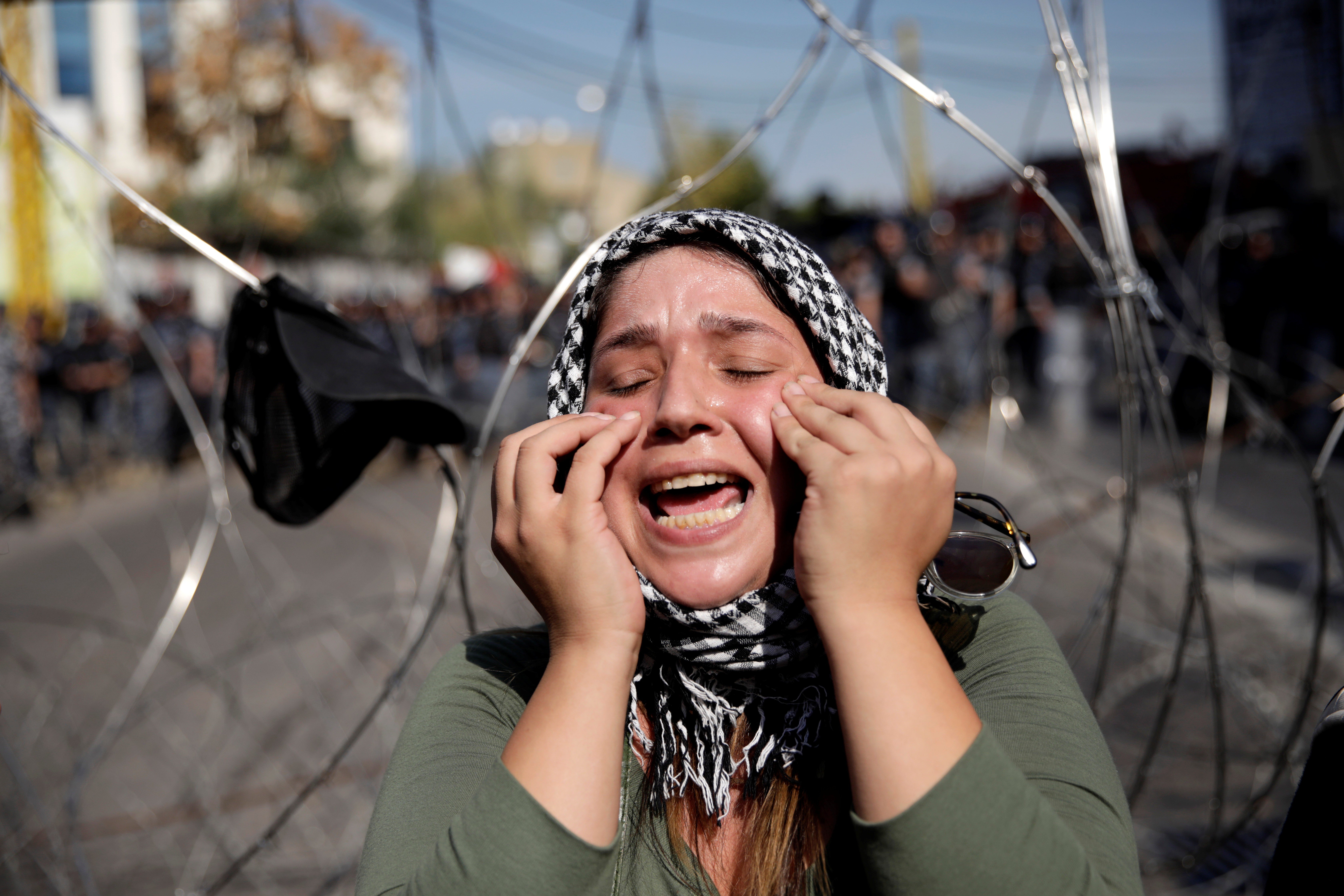 A protester chants slogans next to barbed wire blocking the road to the US embassy in Awkar, Lebanon. Photo: Reuters