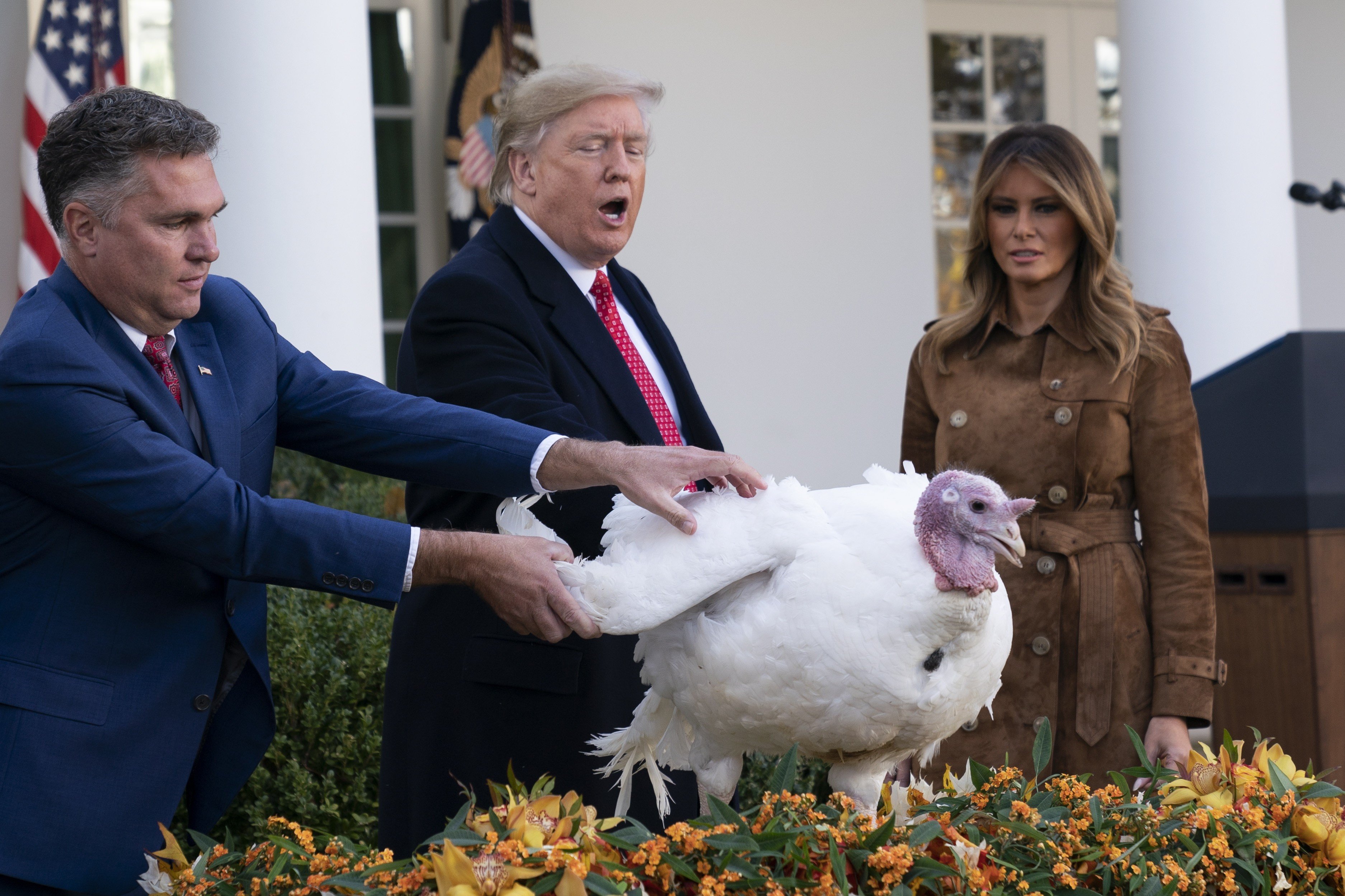 US President Donald Trump pardons a turkey named “Butter” in a Thanksgiving ceremony on November 26, with farmer Wellie Jackson, who raised the bird, and First Lady Melania Trump. Photo: EPA-EFE