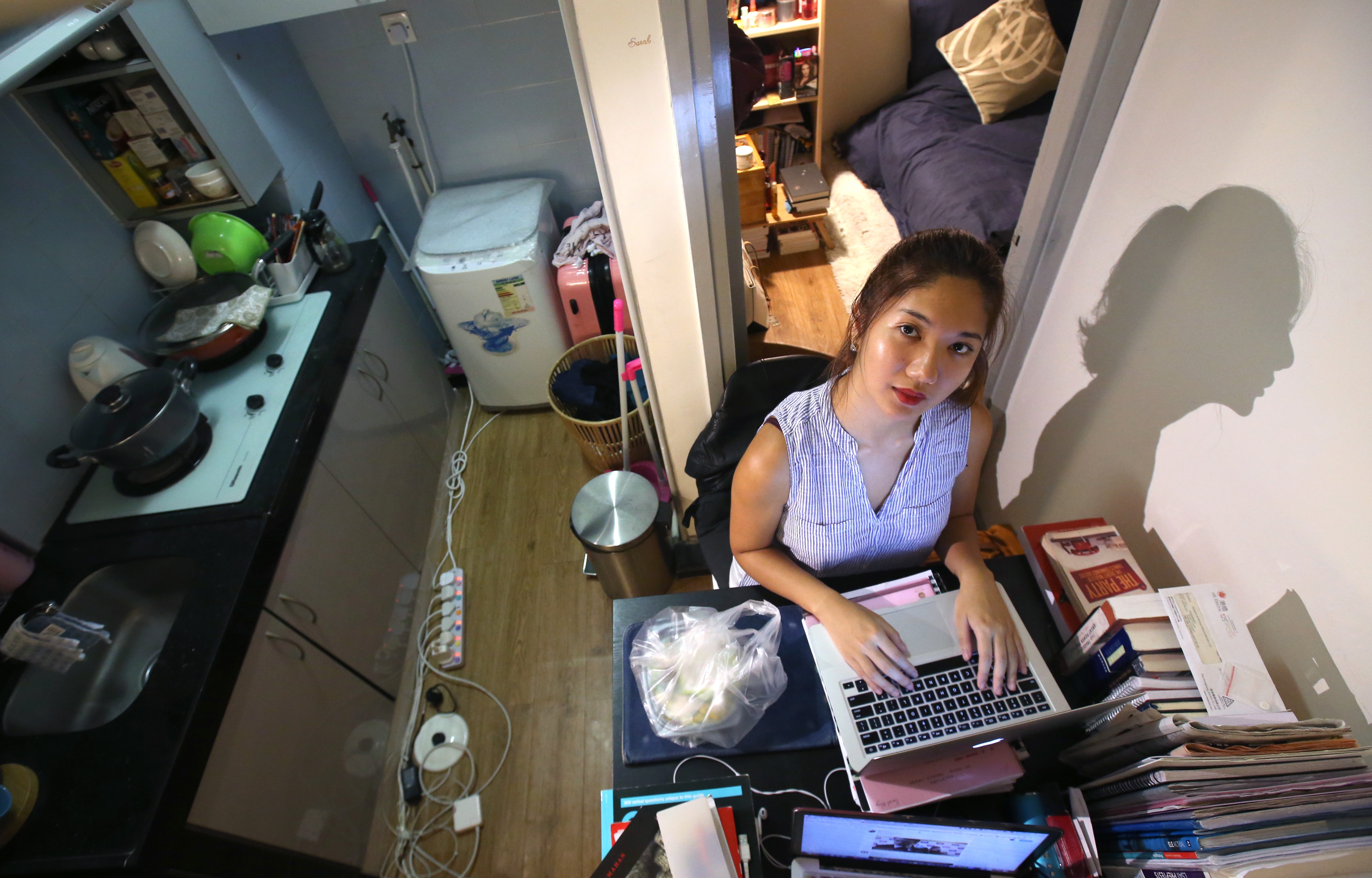 Sarah Wong, then a University of Hong Kong student from Macau, works on her computer in a flat in Sai Ying Pun in October 2017. Wong moved into the apartment with a classmate after she was denied accommodation in the university dorm in the second year of her studies. Photo: David Wong