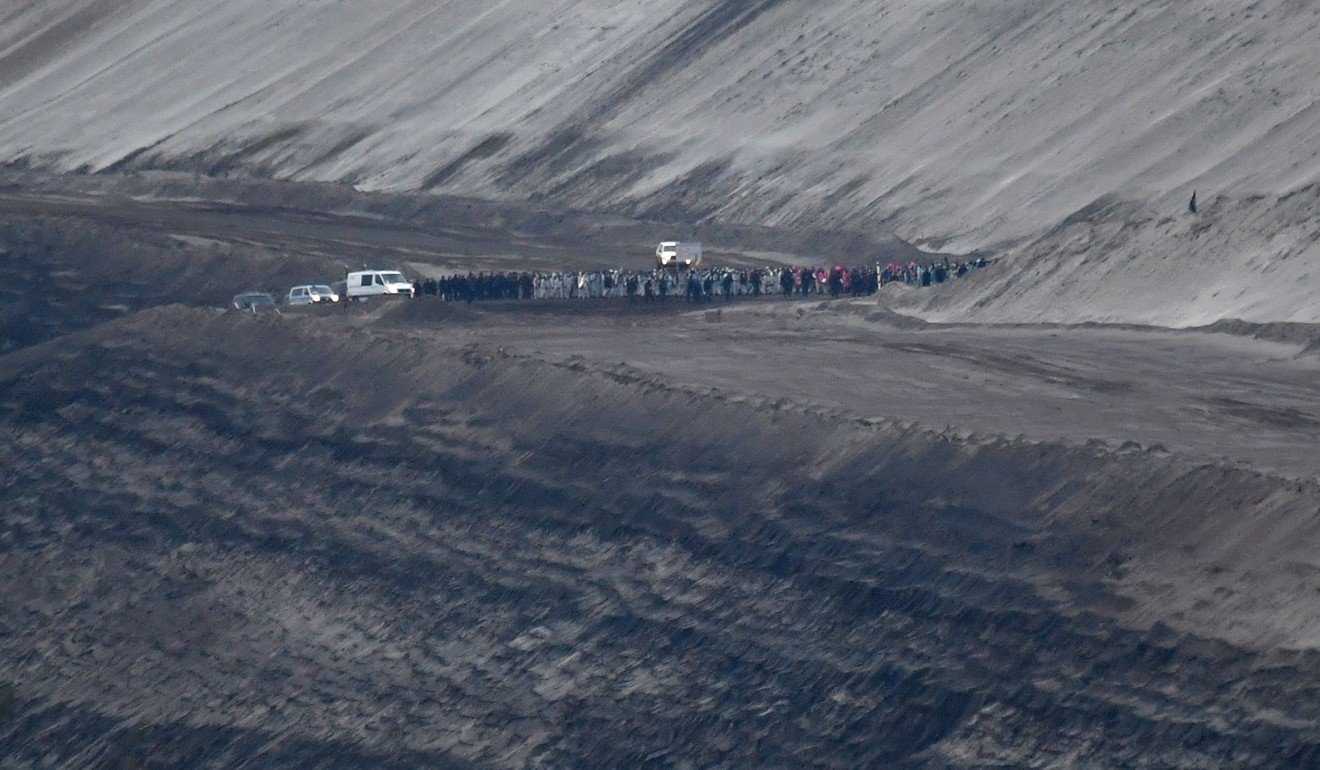 Climate activists are escorted by German police outside the Welzow-Sued open-pit brown coal mine. Photo: AFP