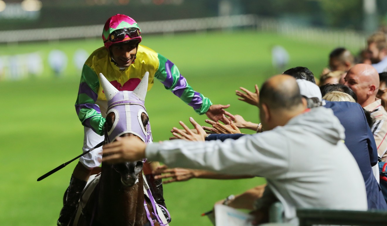 Karis Teetan celebrates a winner with fans at Happy Valley last month.