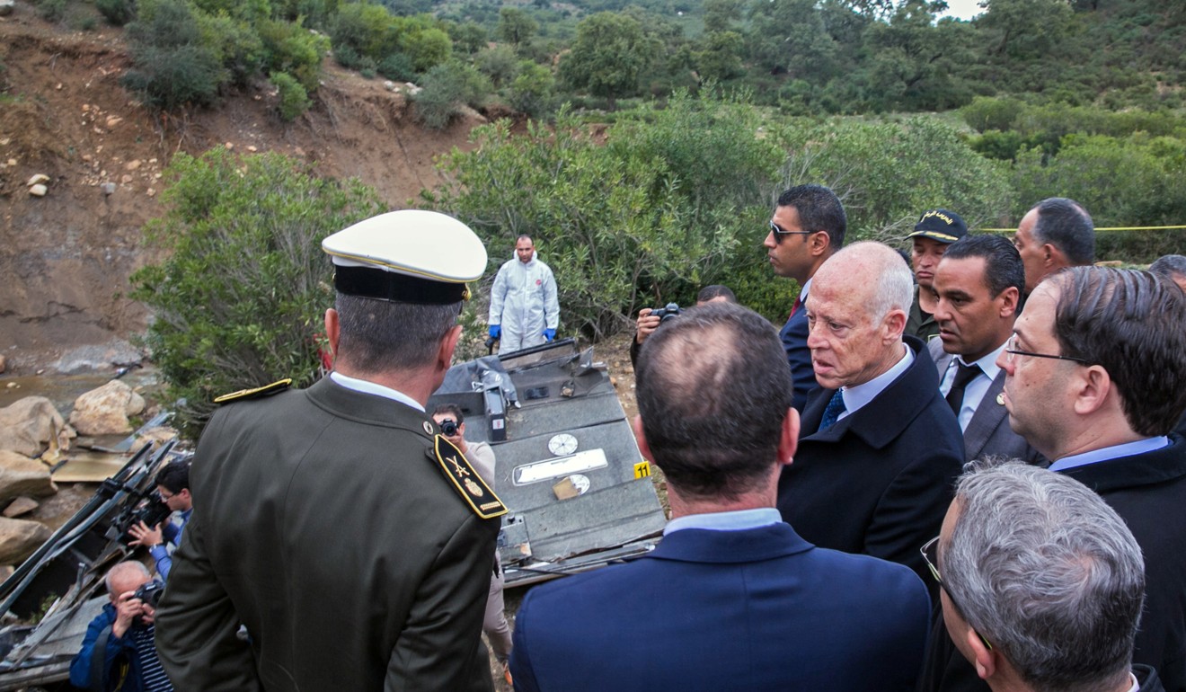 Tunisian President Kais Saied visits the site of a bus crash in the northern town of Amdoun. Photo: Reuters