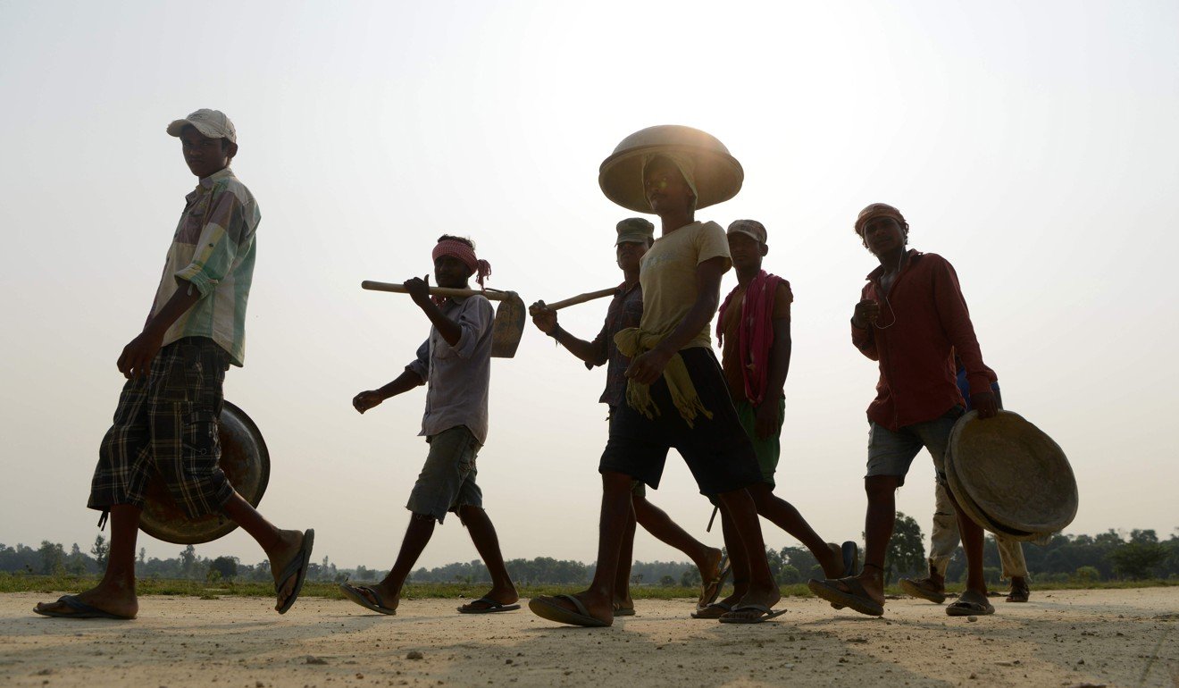 Labourers walk near the construction area of a new railway in Janakpur, some 300km south of Kathmandu. Photo: AFP