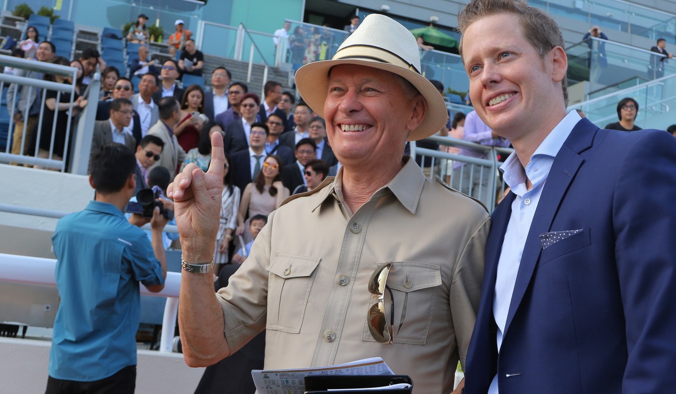 Trainer John Moore (left) celebrates a winner with his son George.