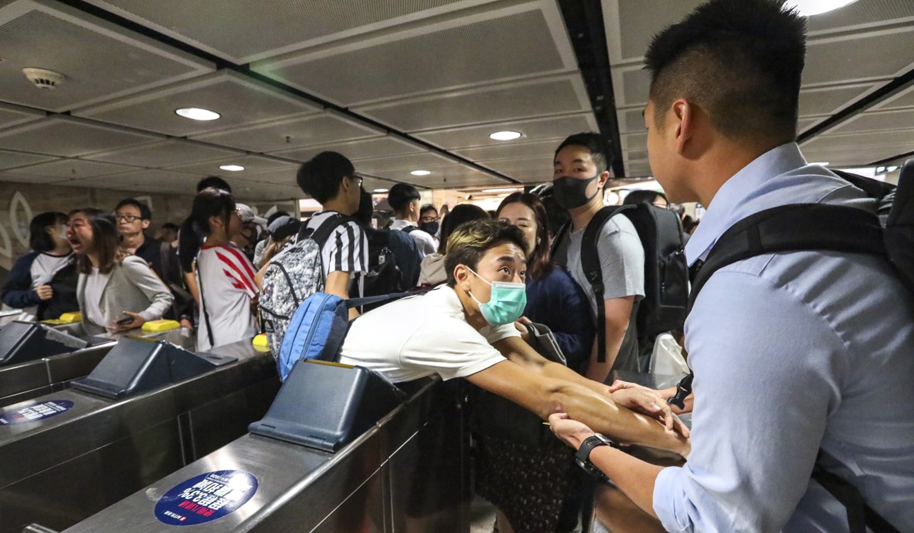Protesters and commuters clash as protesters vandalise Sha Tin MTR station on the early hours of November 11. Photo: Felix Wong