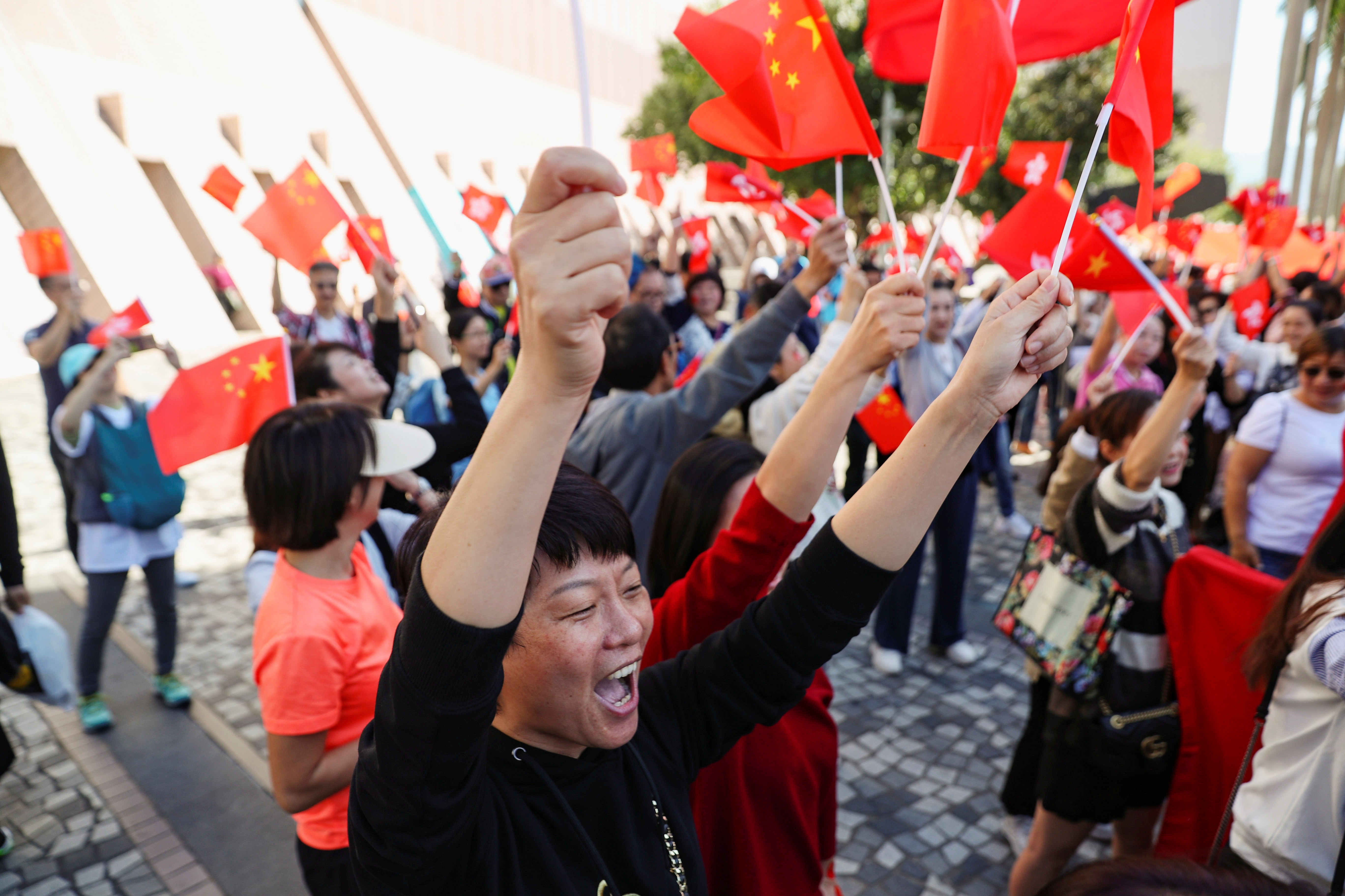 Pro-Beijing supporters sing and wave Chinese flags at a rally underneath the Tsim Sha Tsui clock tower in Hong Kong on December 1. Photo: Reuters