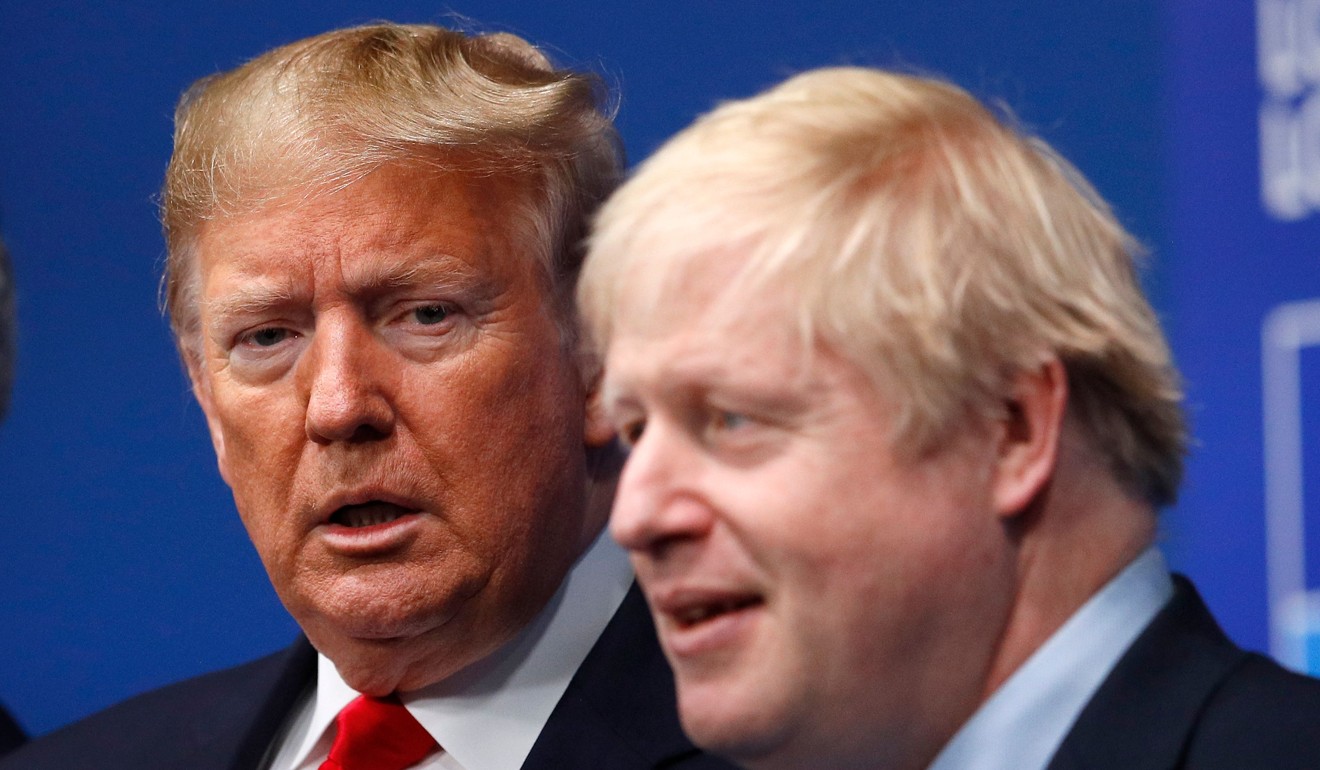 US President Donald Trump looks on as Britain's Prime Minister Boris Johnson welcomes him to the summit. Photo: AFP