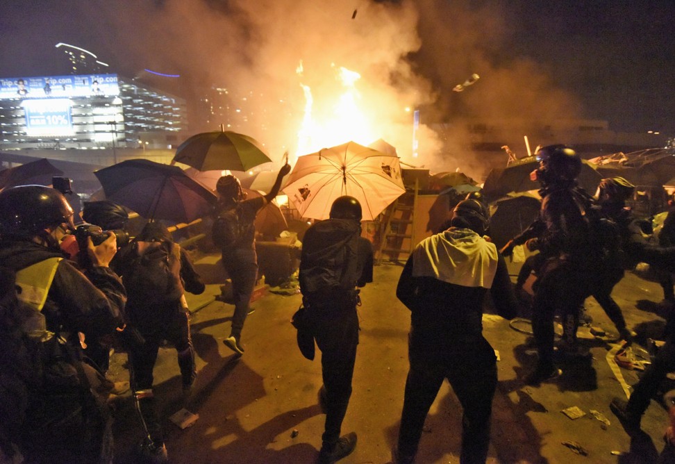 Protesters throw petrol bombs at the police outside Polytechnic University in Hung Hom on November 17. Photo: Kyodo