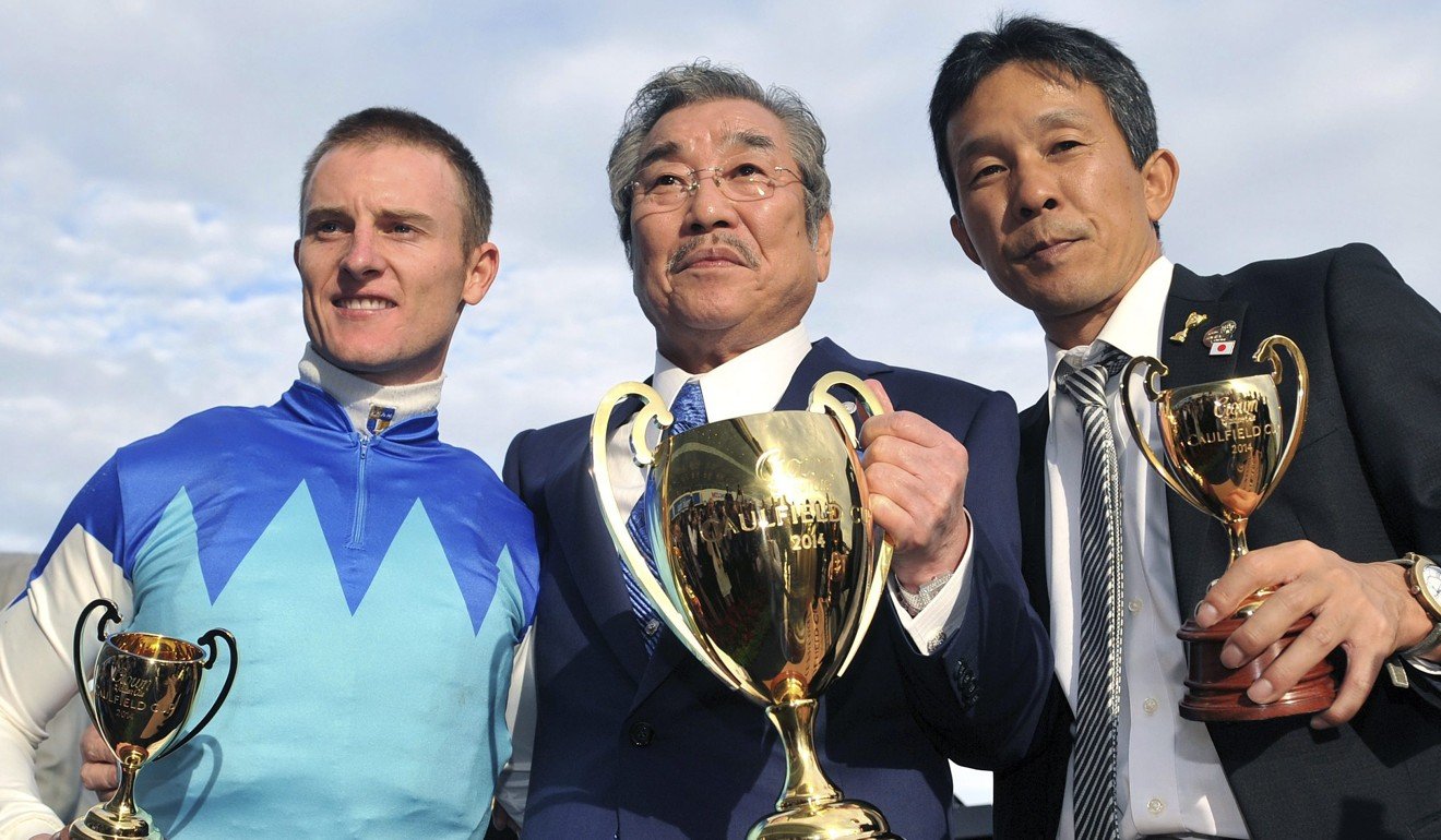 Jockey Zac Purton (left), owner Riichi Kondo (middle) and trainer Tomoyuki Umeda celebrate Admire Rakti’s 2014 Caulfield Cup win.