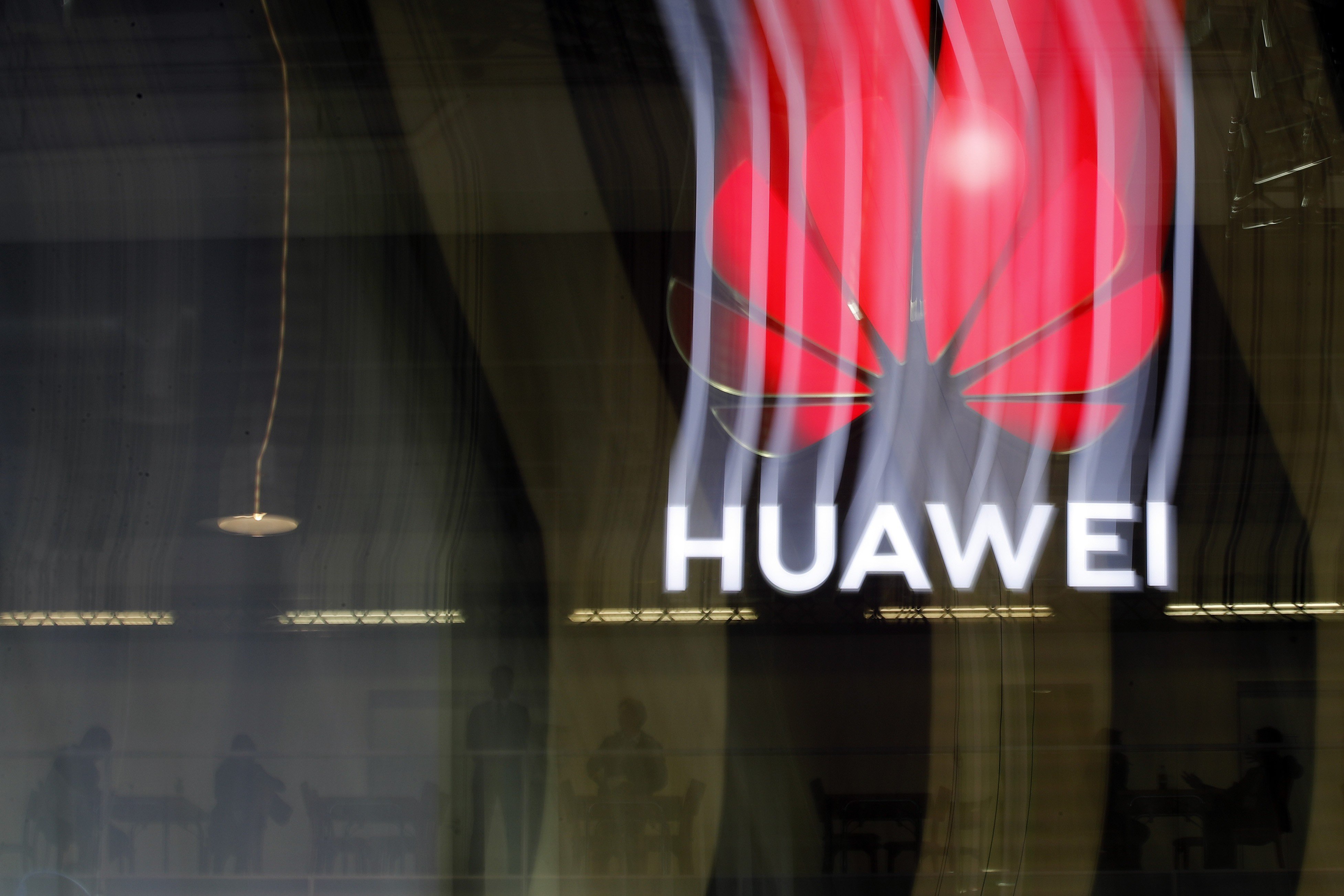 In this file photo taken on October 15, 2019 an illuminated Huawei sign is on display during the 10th Global mobile broadband forum hosted by Huawei in Zurich. Photo: AFP