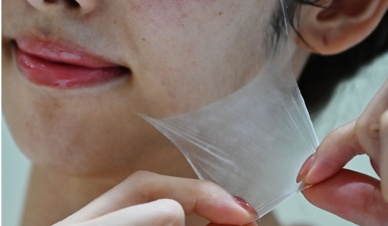 The employee removes a super thin transparent layer. Photo: AFP