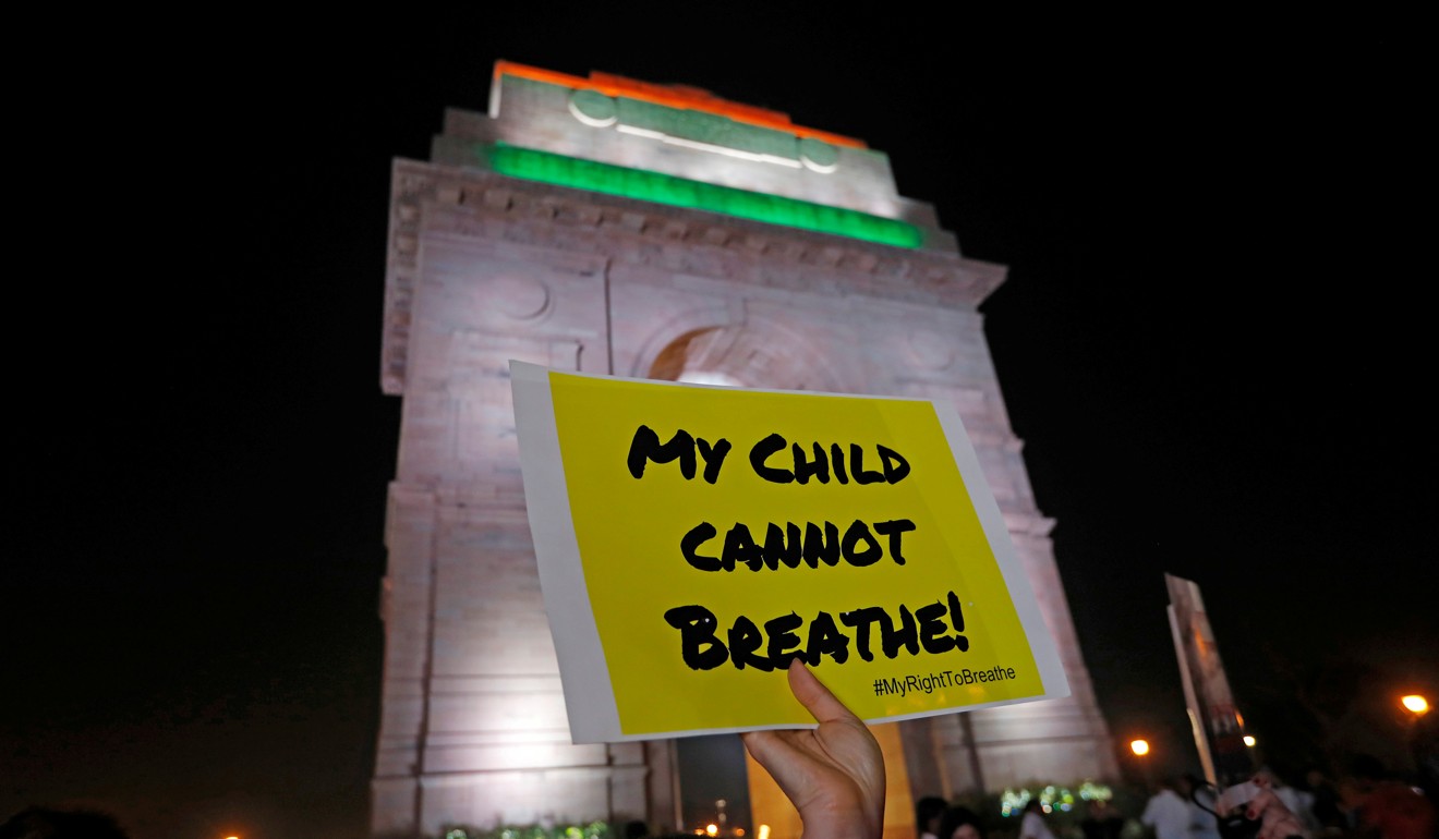 A protester holds a placard in front of the India Gate in New Delhi on November 5, demanding the government take immediate steps to control air pollution in the city. Photo: Reuters
