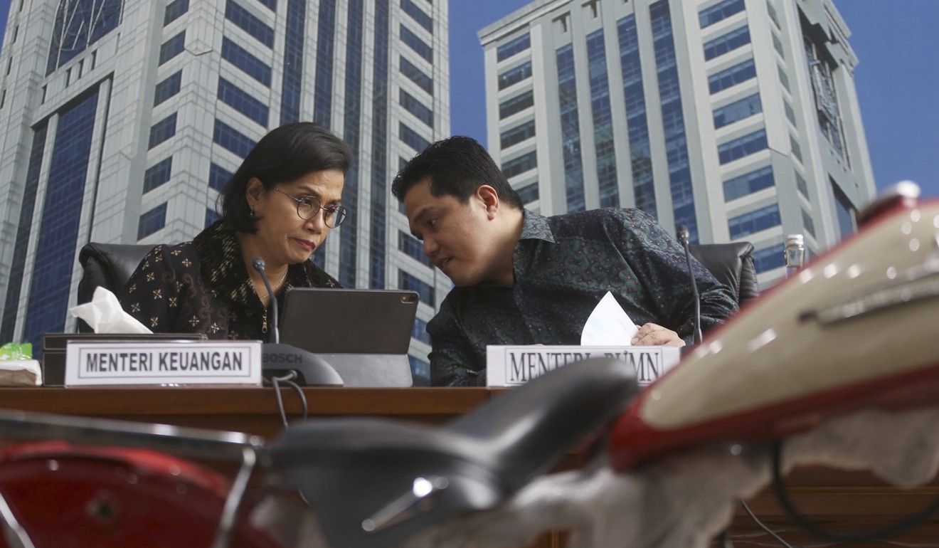 Indonesian Finance Minister Sri Mulyani Indrawati, left, confers with Minister of State-Owned Enterprises Eric Thohir. Photo: AP