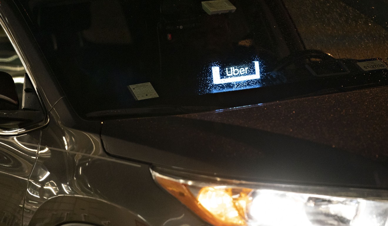 Uber signage displayed in a vehicle in Arlington, Virginia, United States. Photo: Bloomberg