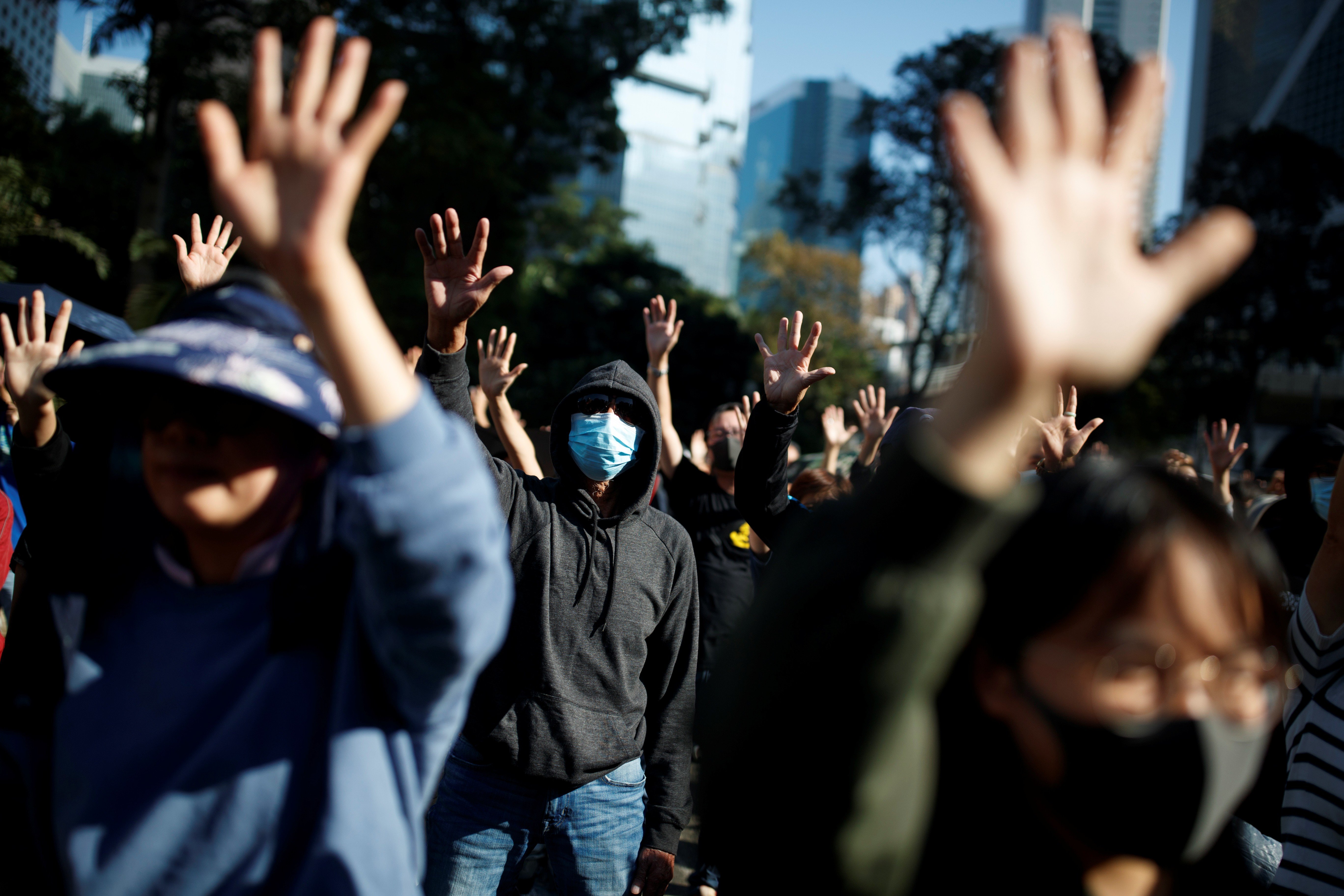 People raise their hands as they sing the protest anthem “Glory to Hong Kong” during an anti-government protest in the Central district of Hong Kong on November 30. Photo: Reuters
