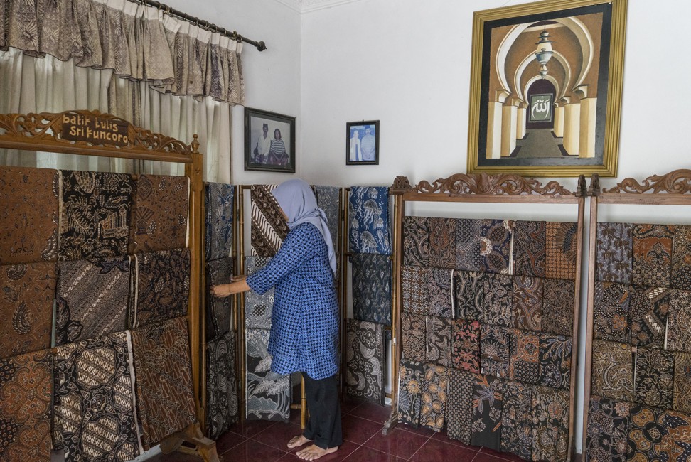 Imaroh shows off a selection of batik. Photo: Hendra Nurdiyansyah