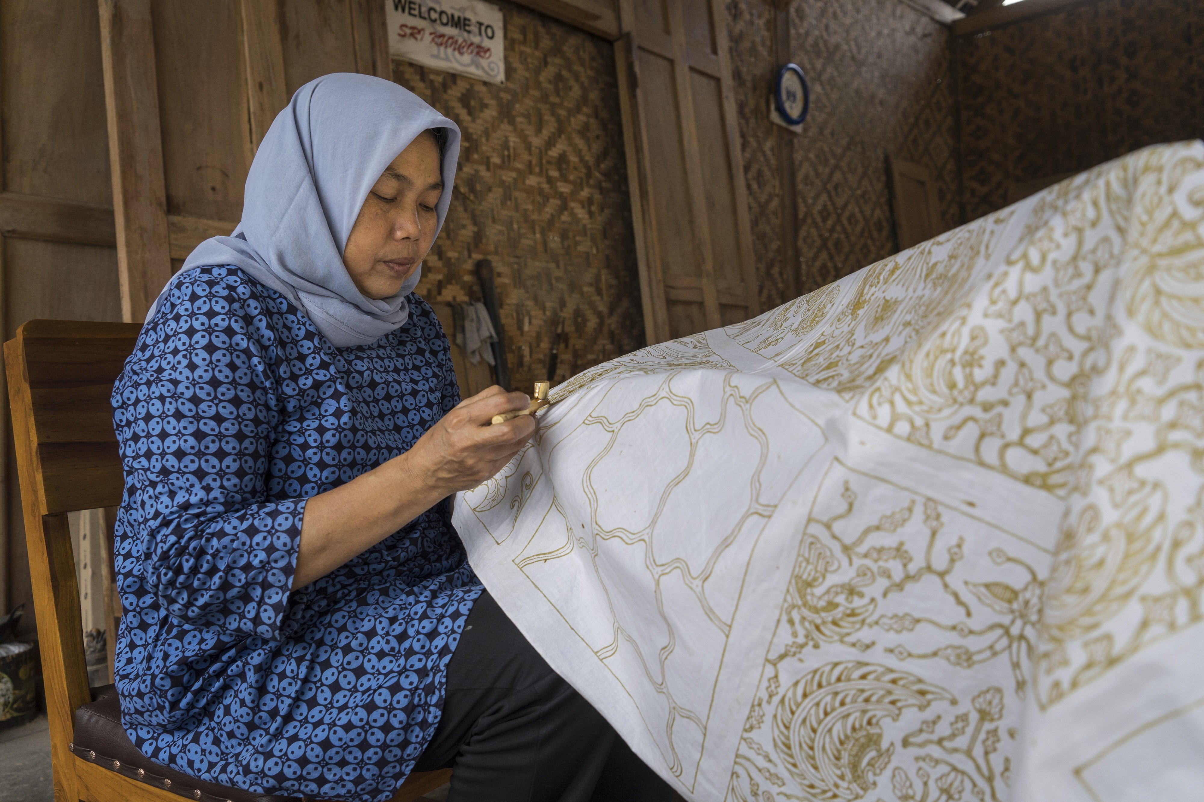 Batik crafter Imaroh works on a design in Imogiri, Yogyakarta, Indonesia. She has been making batik since she was 10 years old. Photo: Hendra Nurdiyansyah